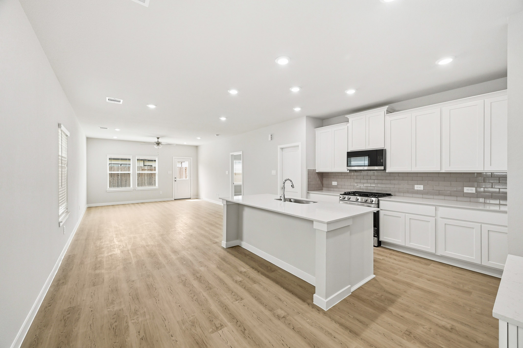 A kitchen with white cabinets.