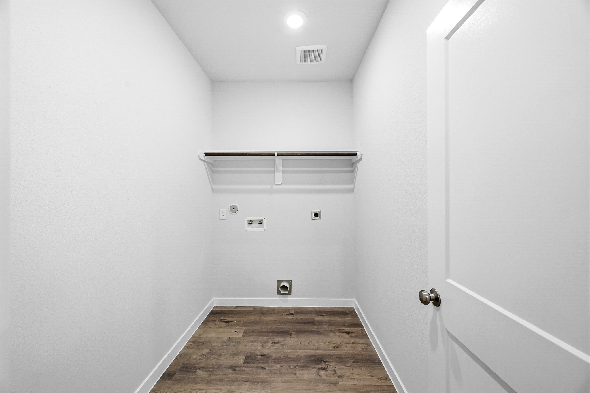 A white room with a wood floor.