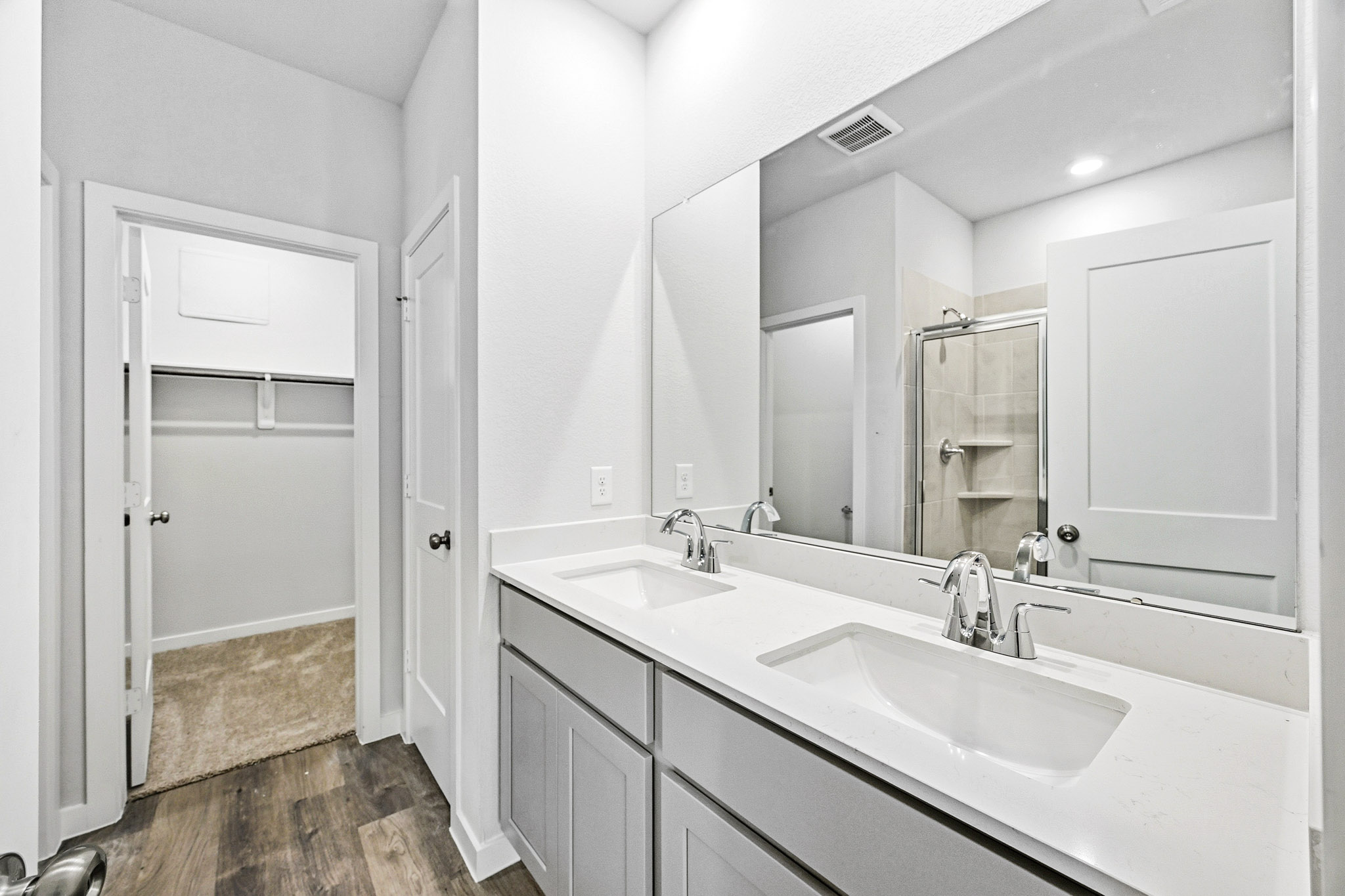 A bathroom with a large mirror.