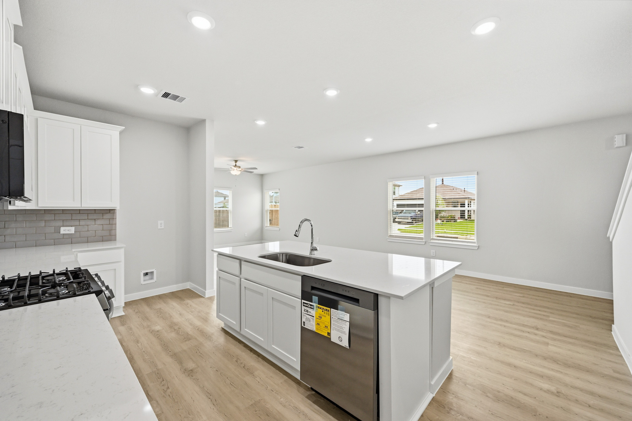 A kitchen with white cabinets.