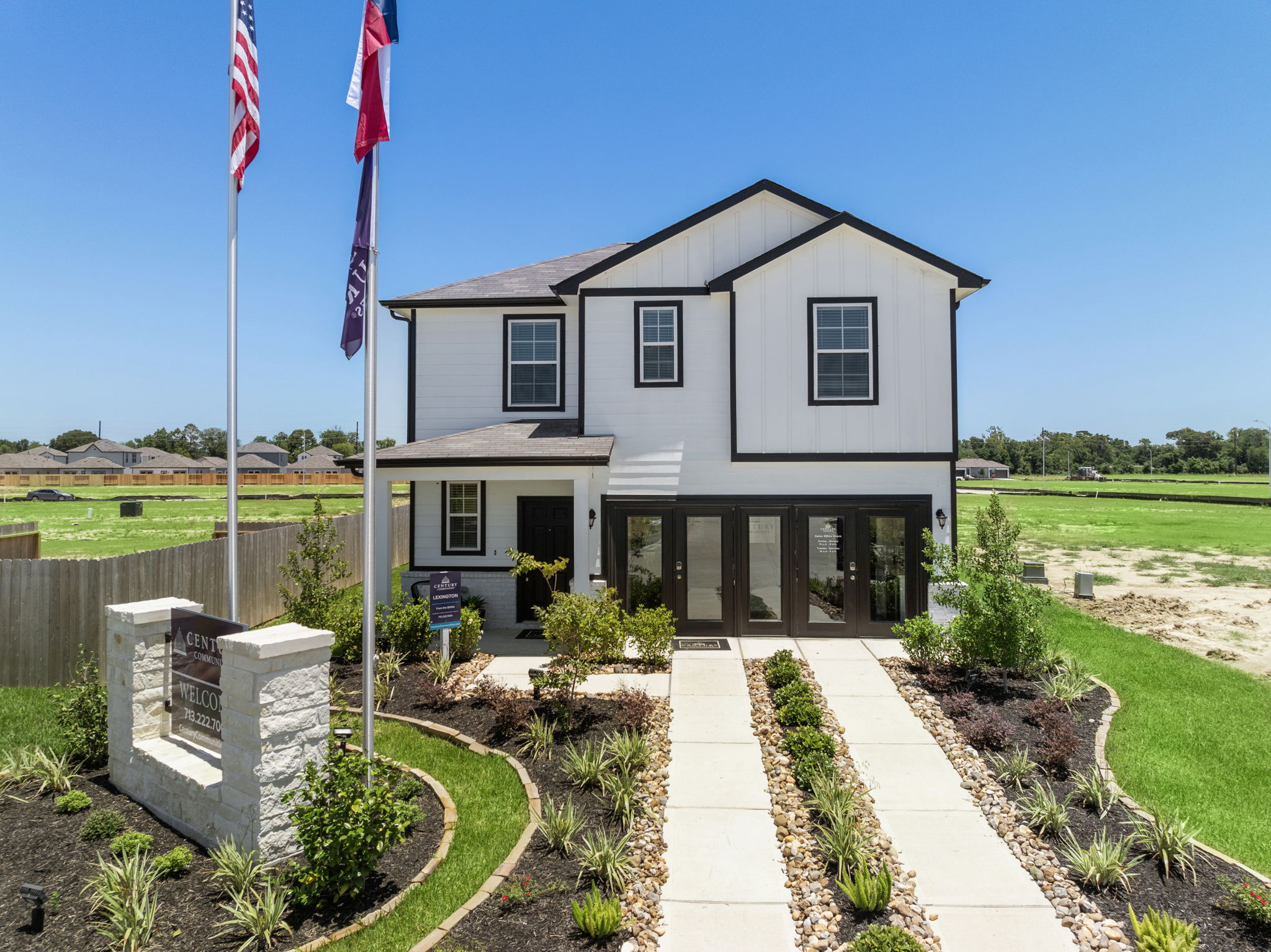 A white house with flags.