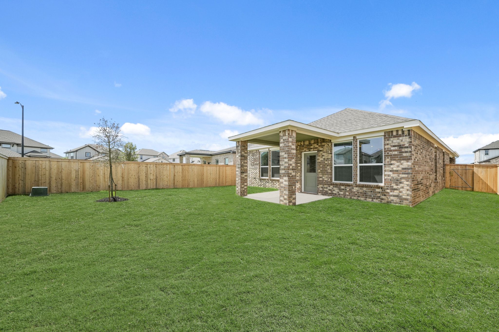 A house with a fence and grass.