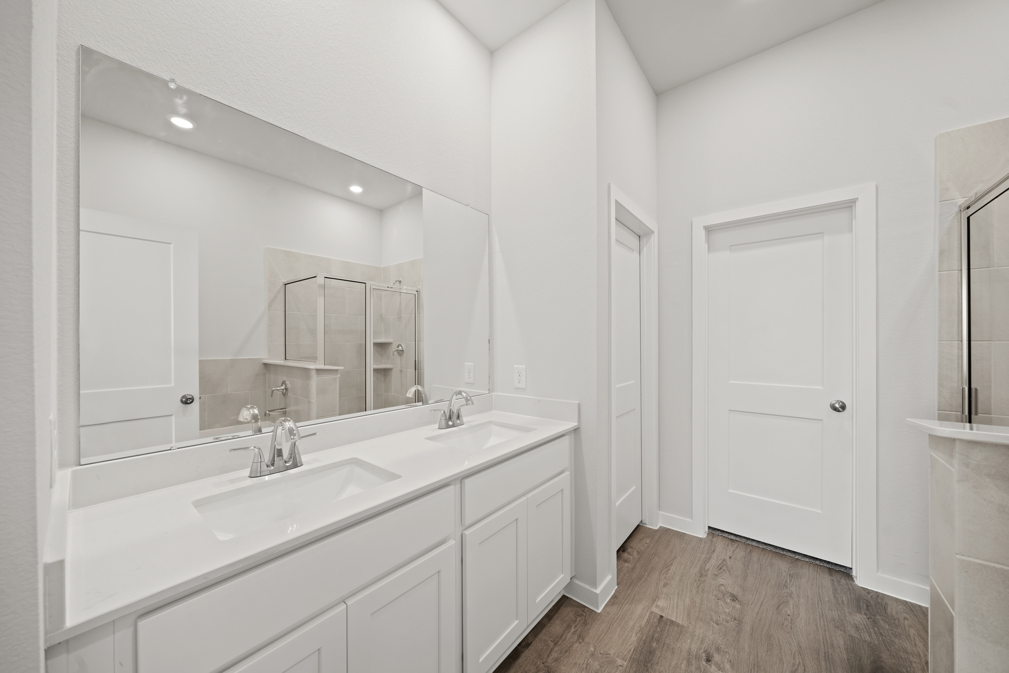 A bathroom with white cabinets.