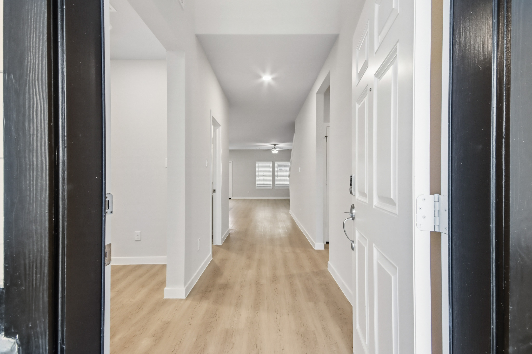 A hallway with white doors.