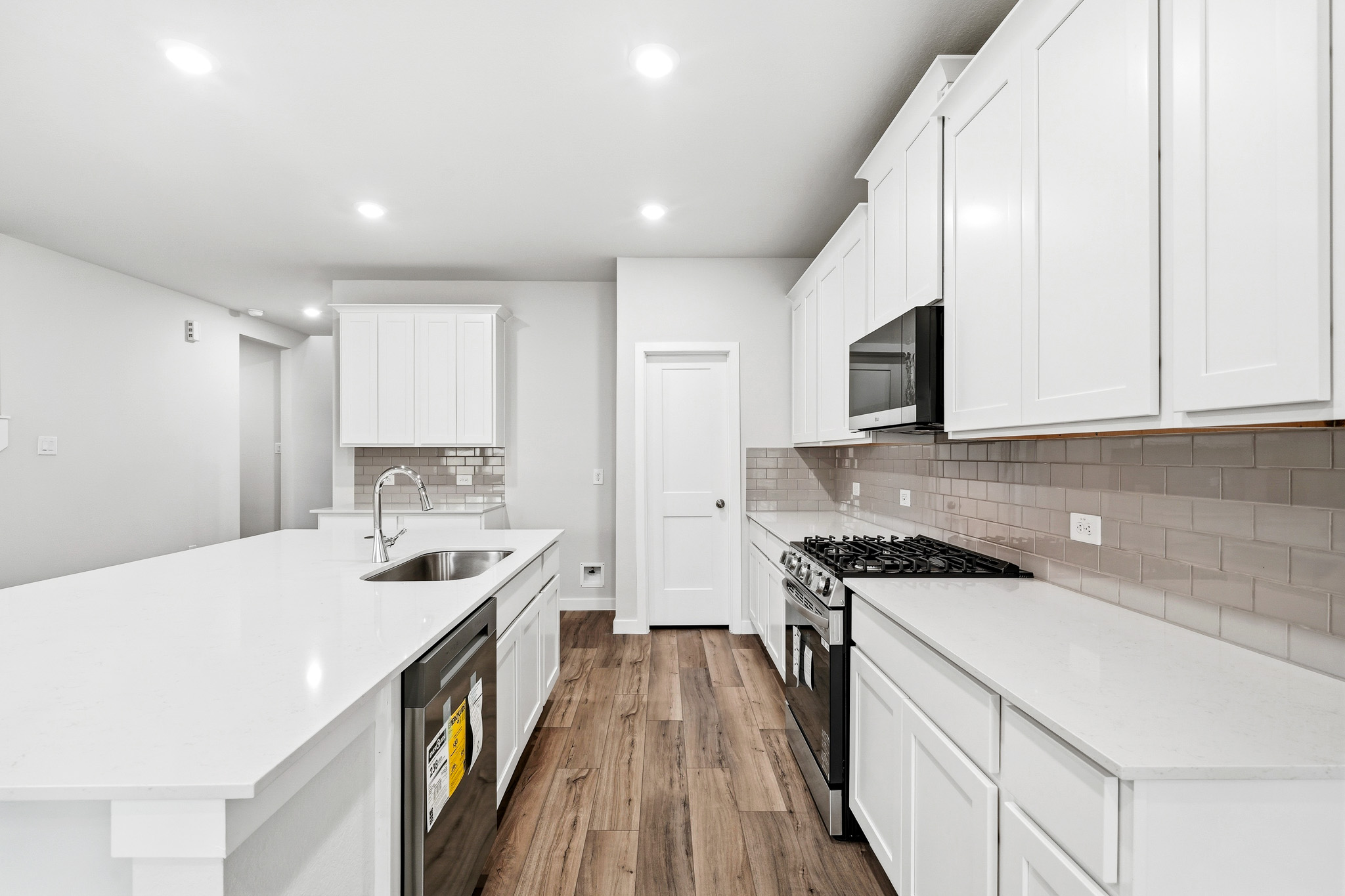 A kitchen with white cabinets.