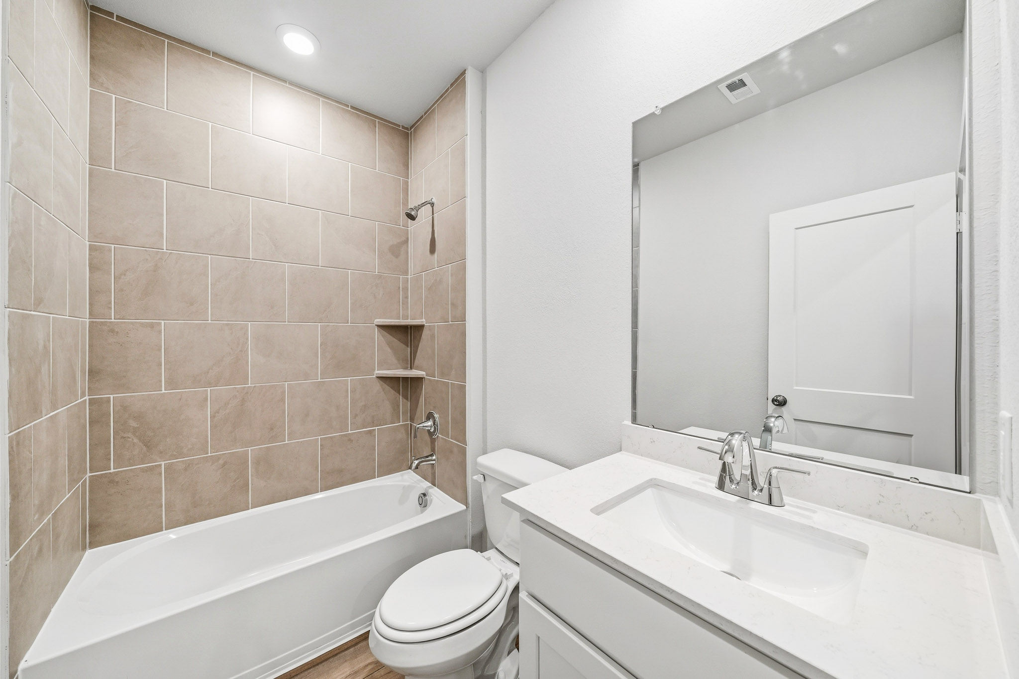 A bathroom with a tub sink and toilet.