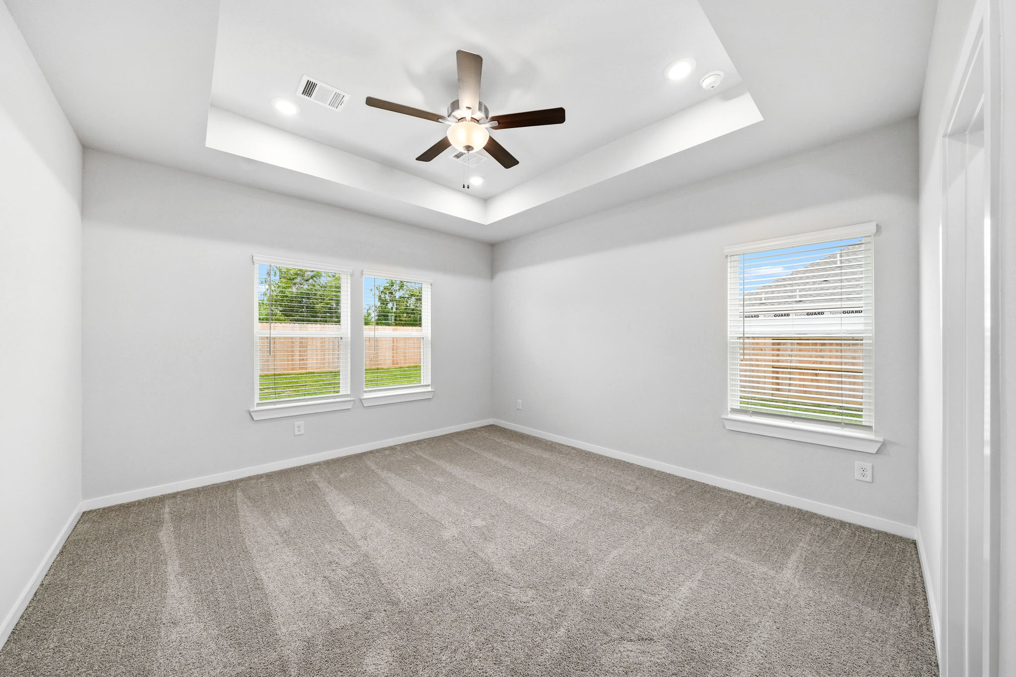 A room with a ceiling fan and a window.