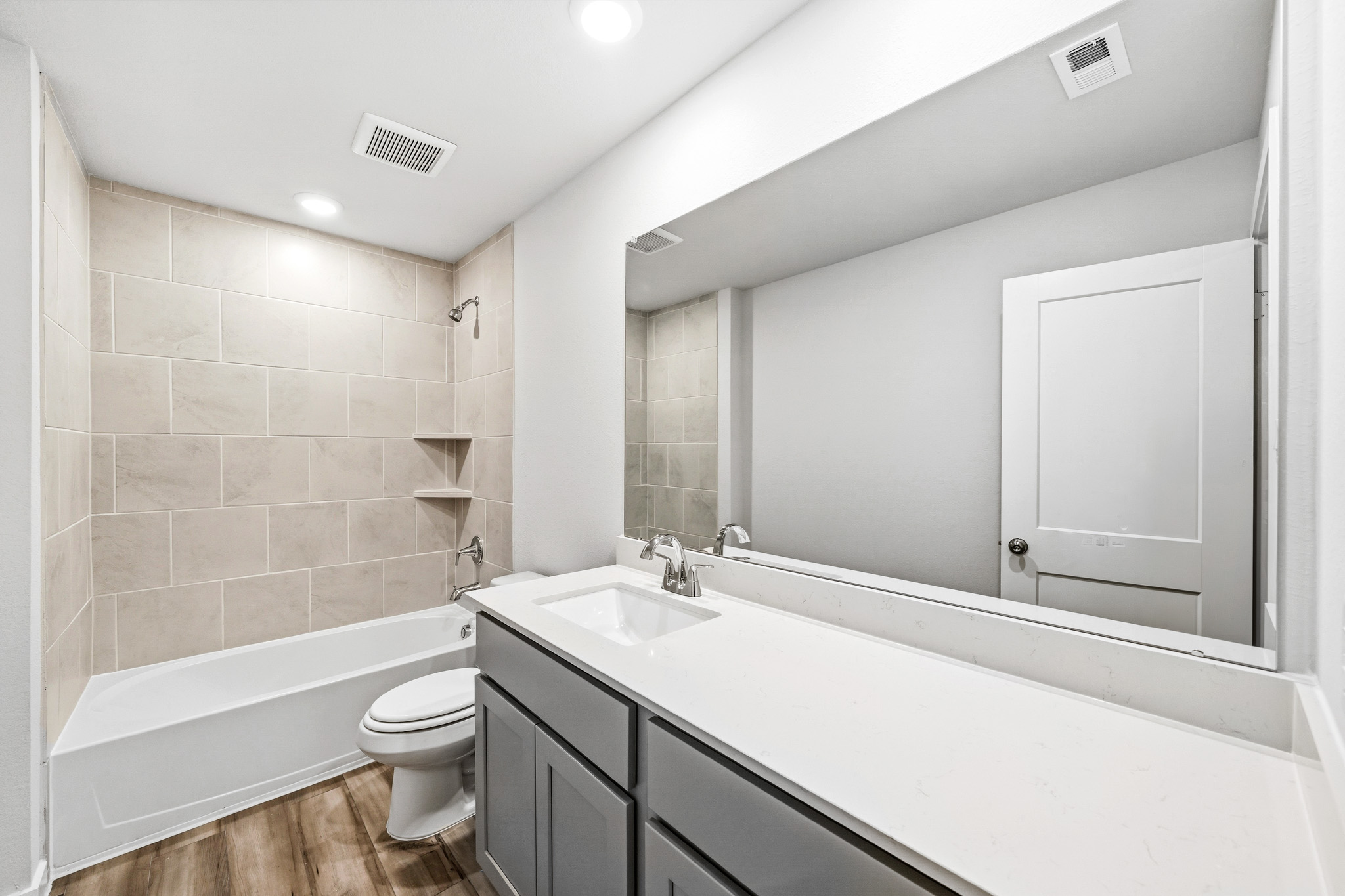 A bathroom with a tub sink and toilet.