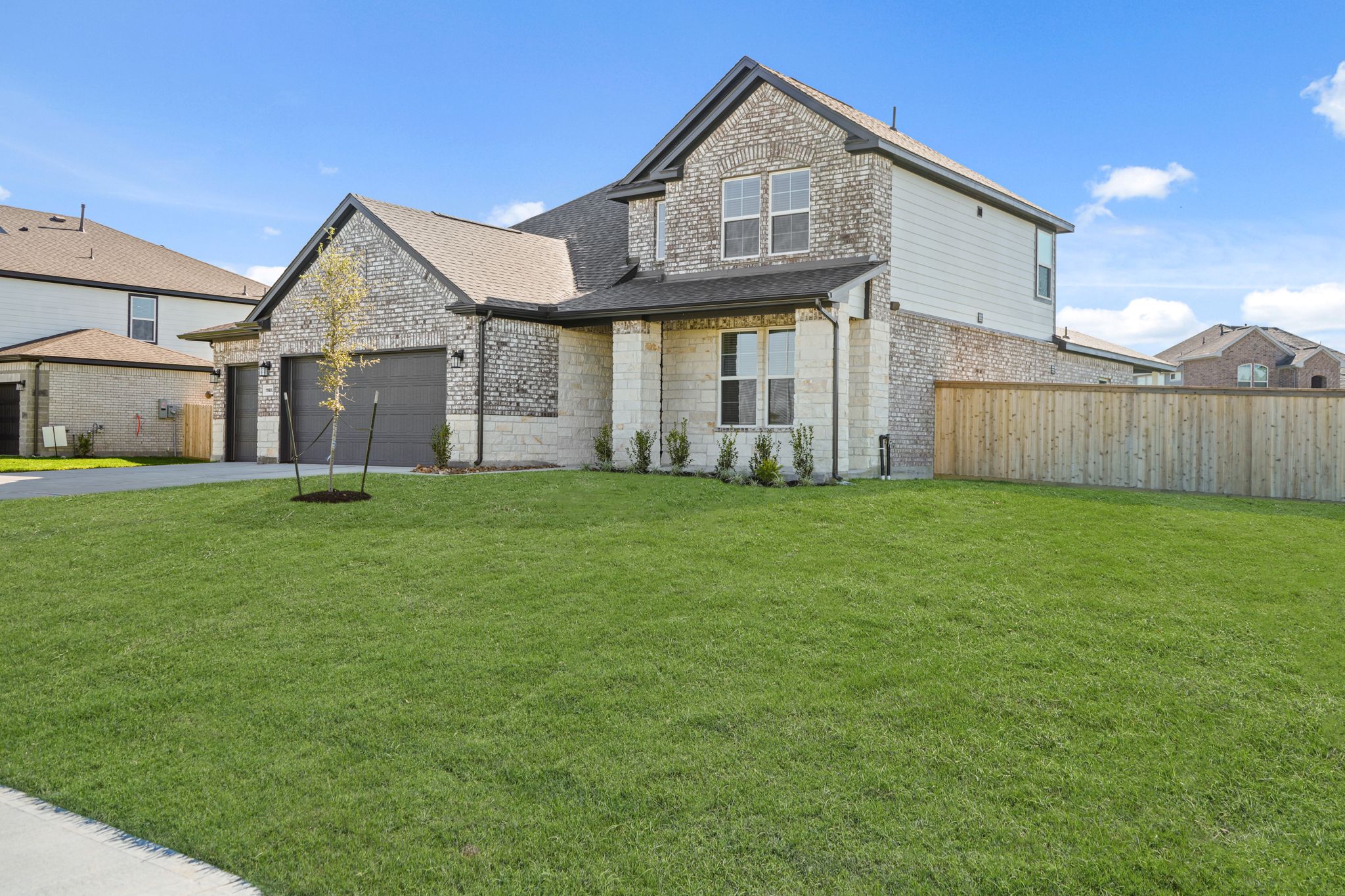 A large house with a green lawn.