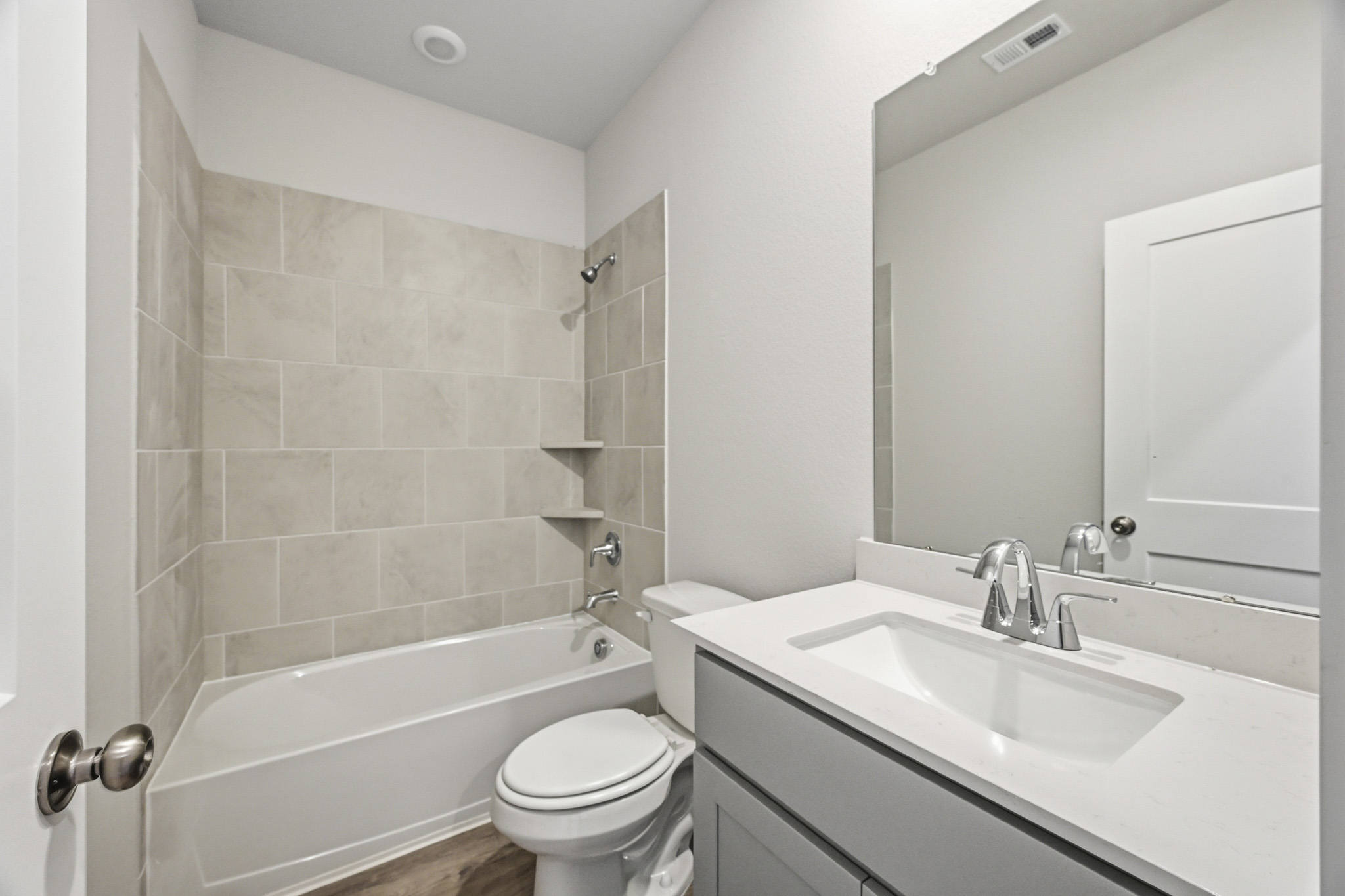A bathroom with a sink toilet and bathtub.