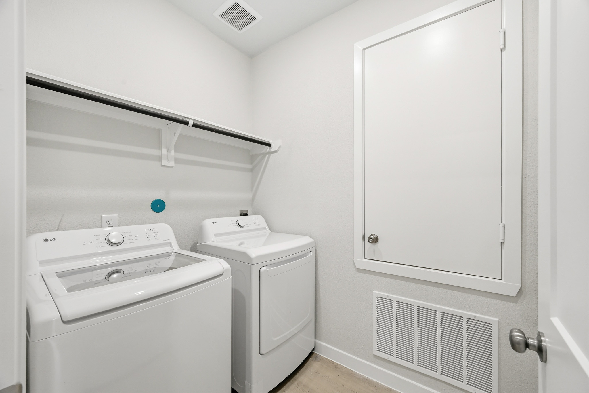 A washing machine and dryer in a room.
