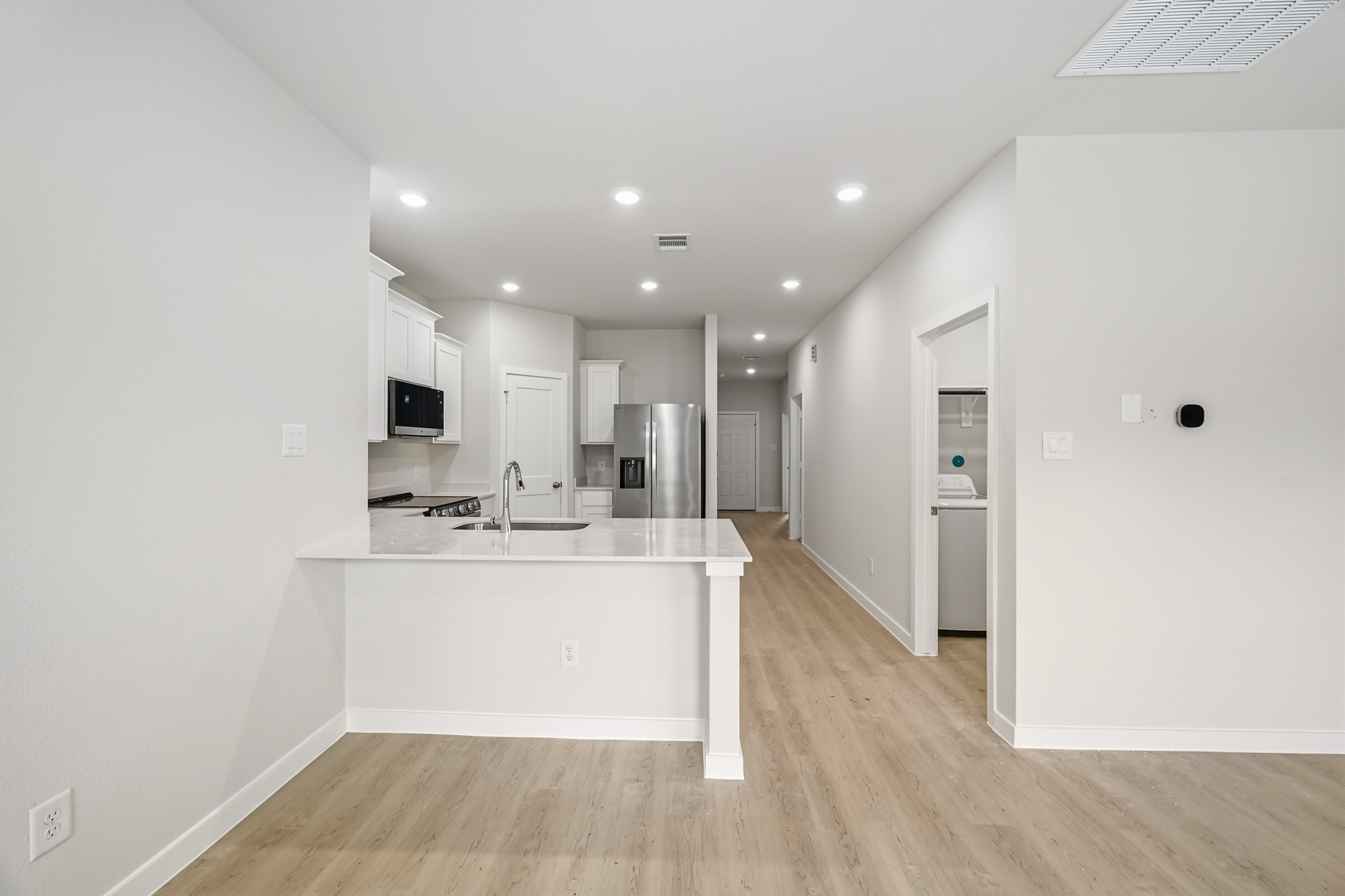 A kitchen with white walls.