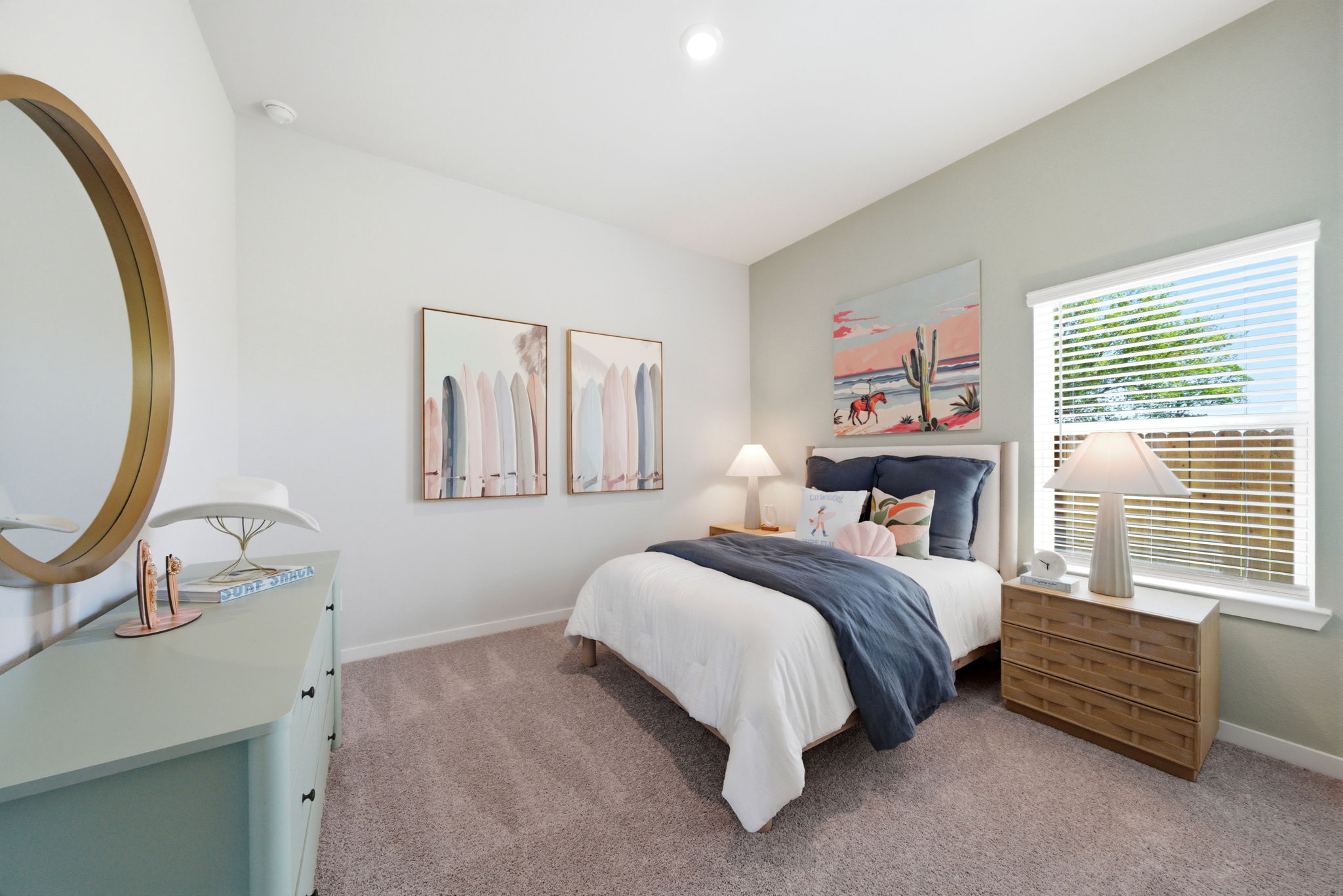 A bedroom with a bed and a mirror.