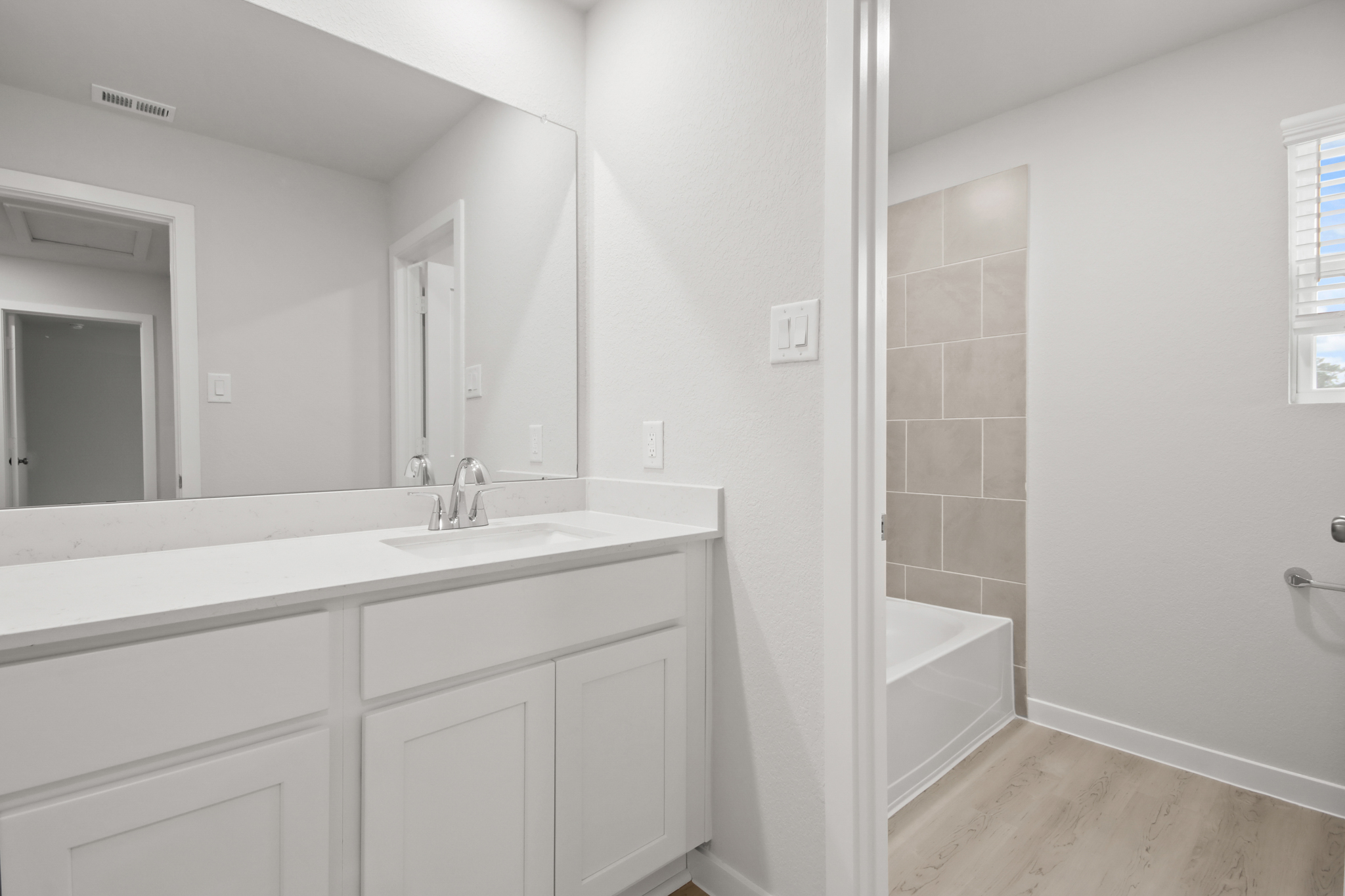 A bathroom with a sink and a bathtub.