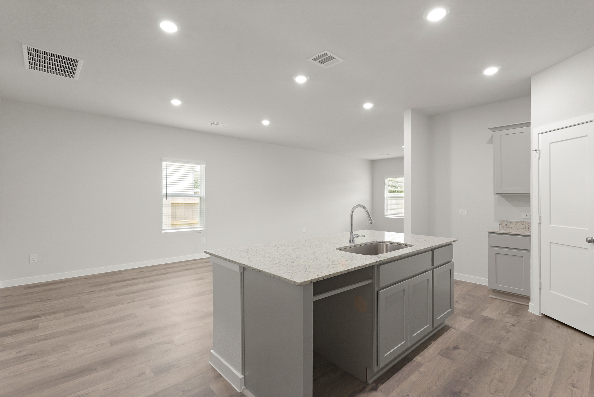 A kitchen with a sink and cabinets.