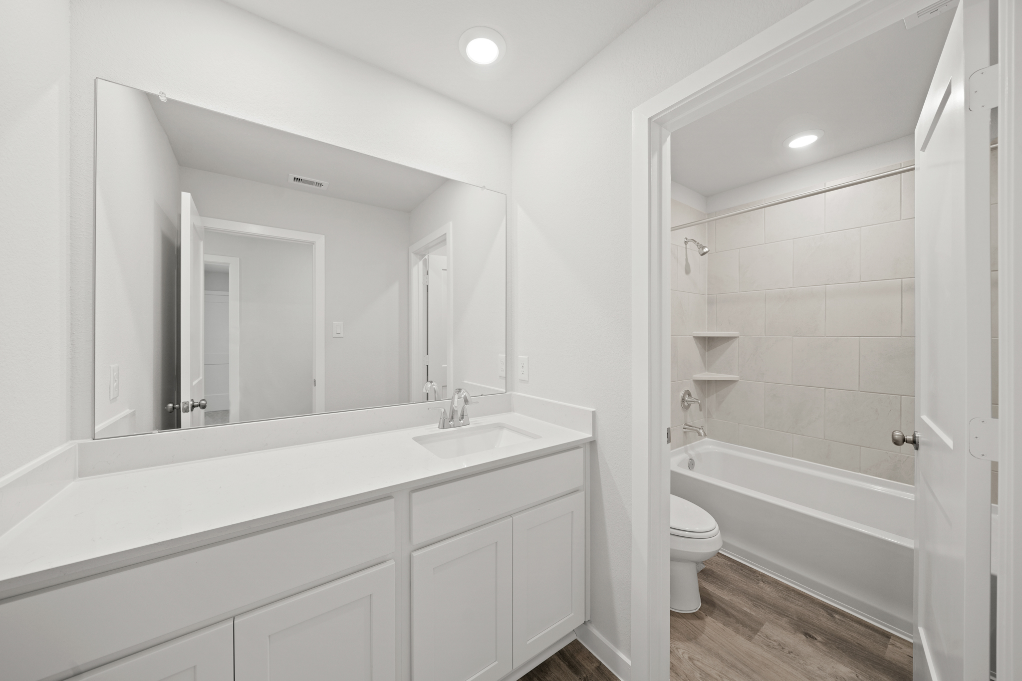 A bathroom with a tub toilet and sink.