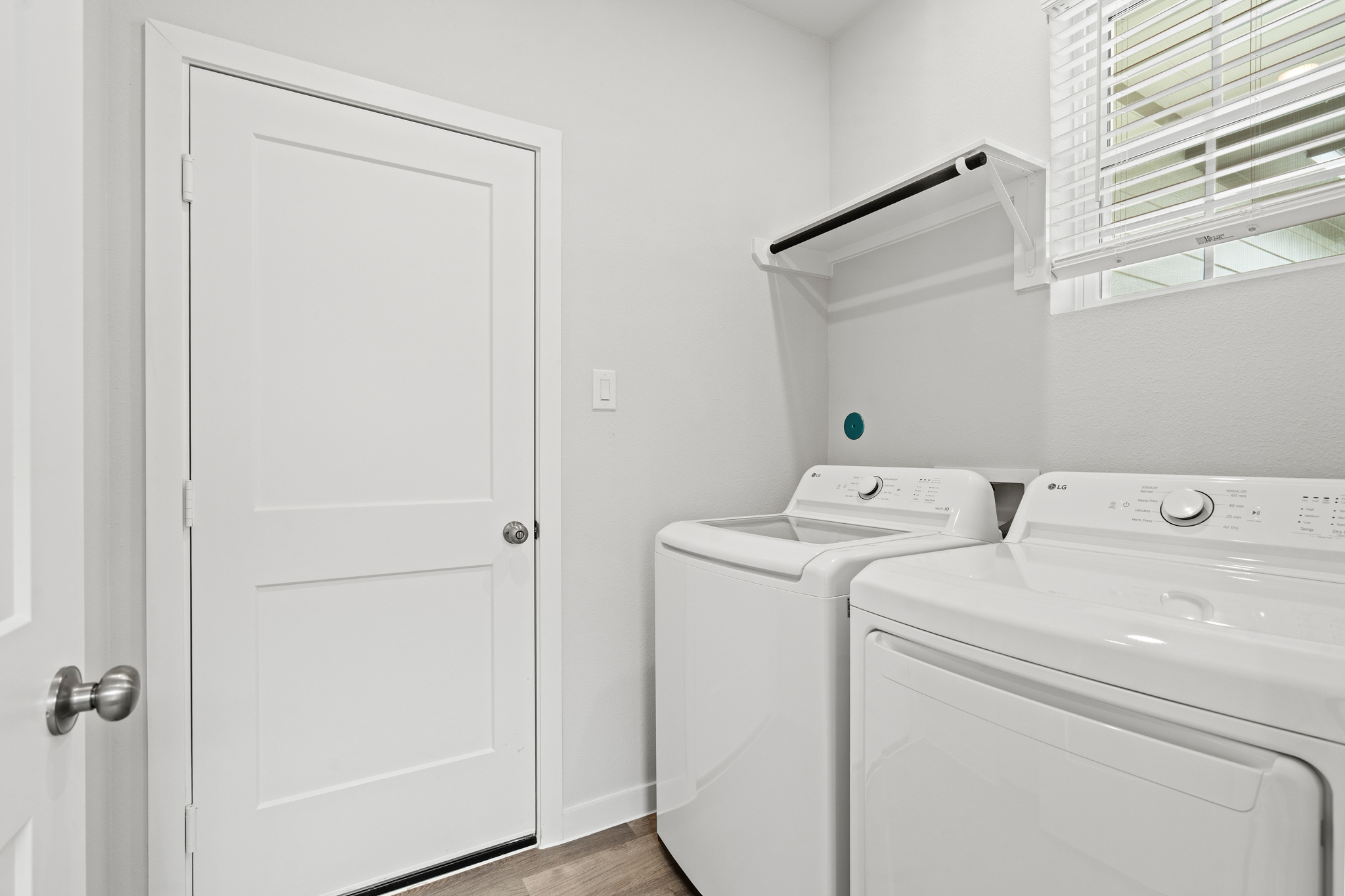 A white washing machine and a white door in a room.