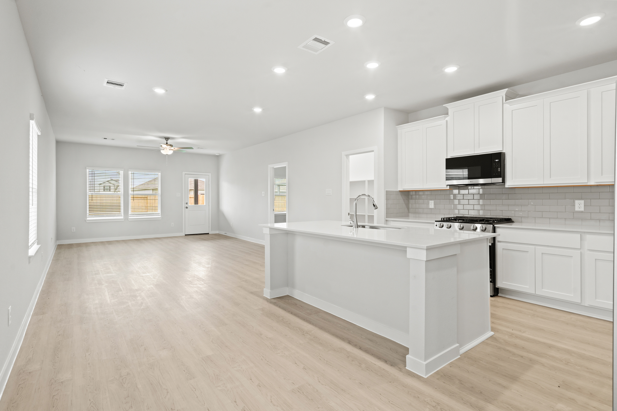 A kitchen with white cabinets.