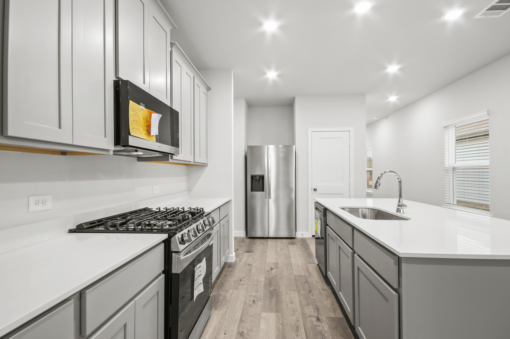 A kitchen with white cabinets.