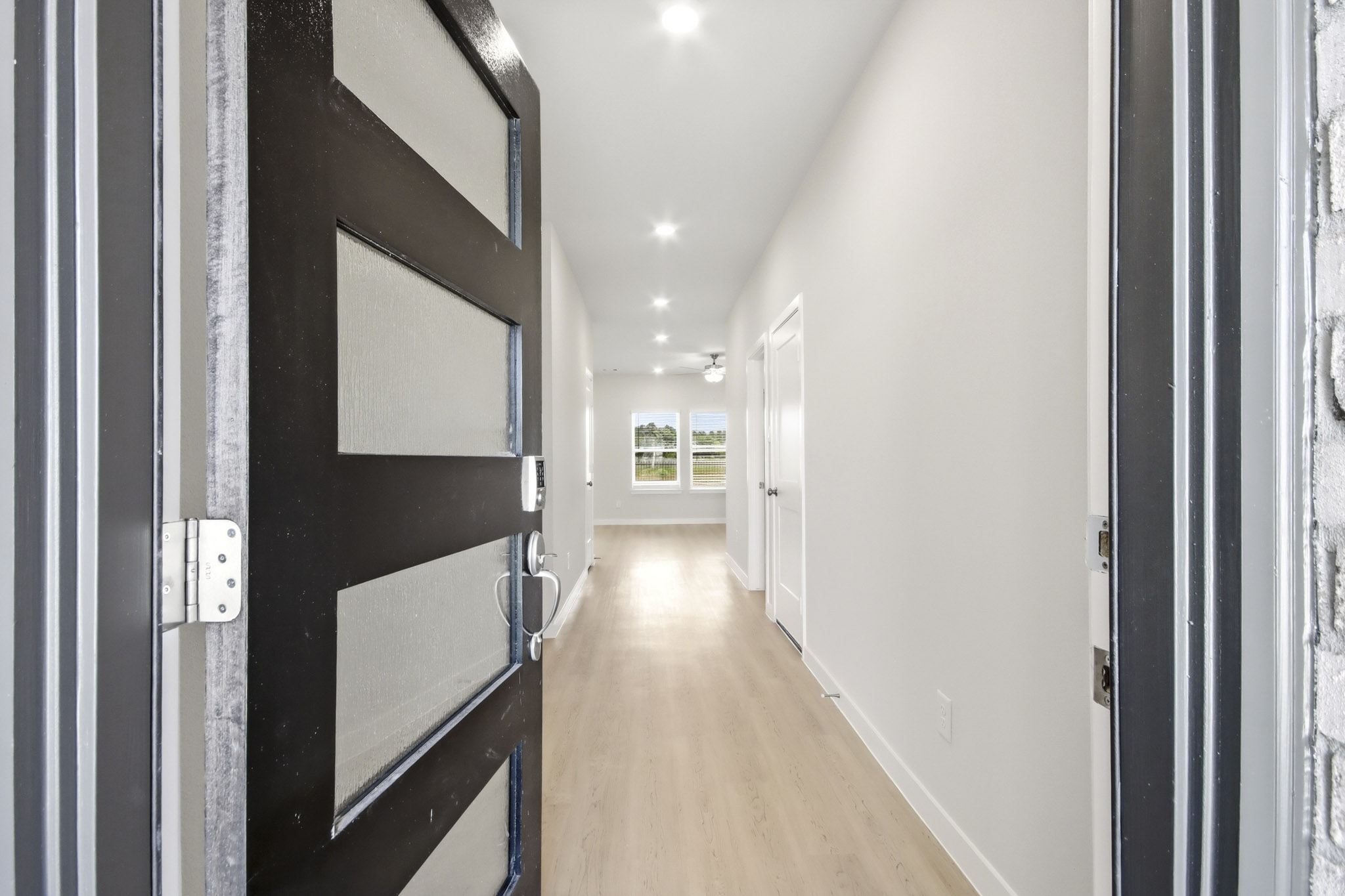 A hallway with black doors.