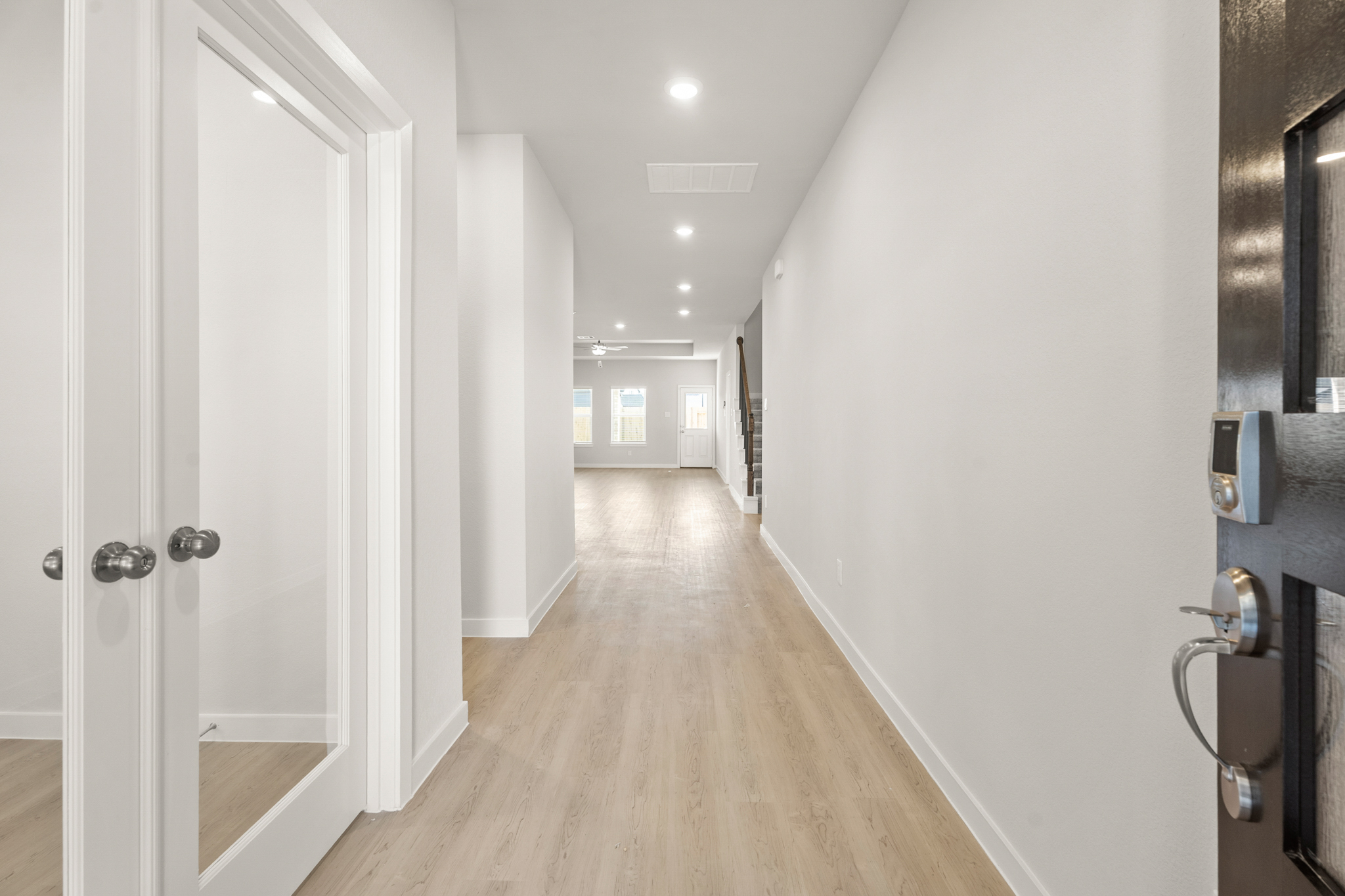 A hallway with white doors.