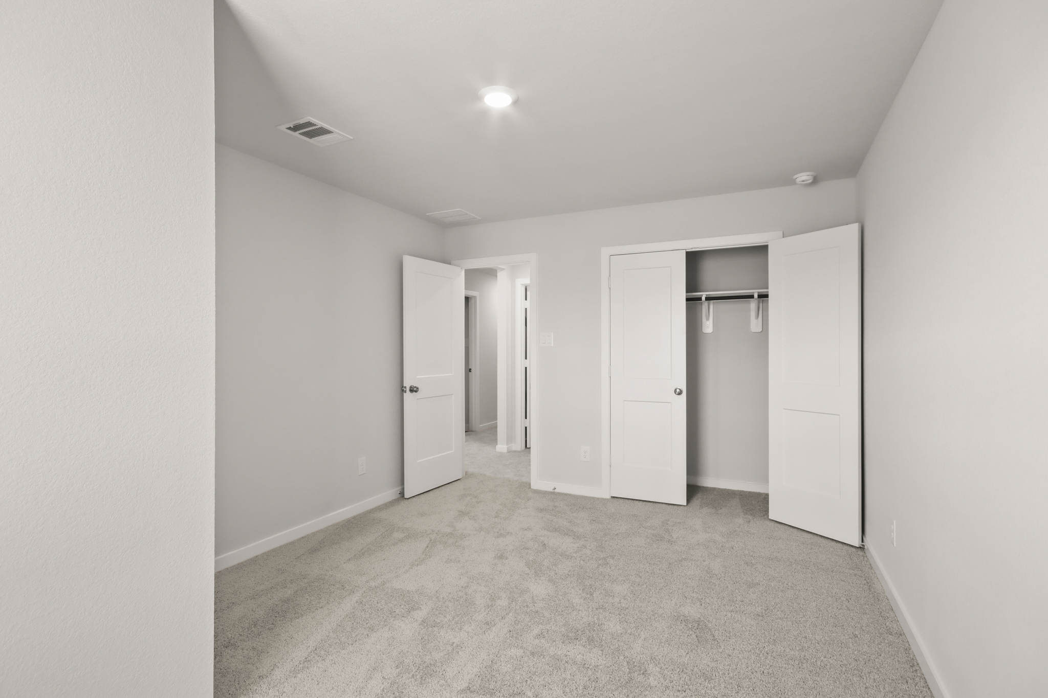 A hallway with white doors.