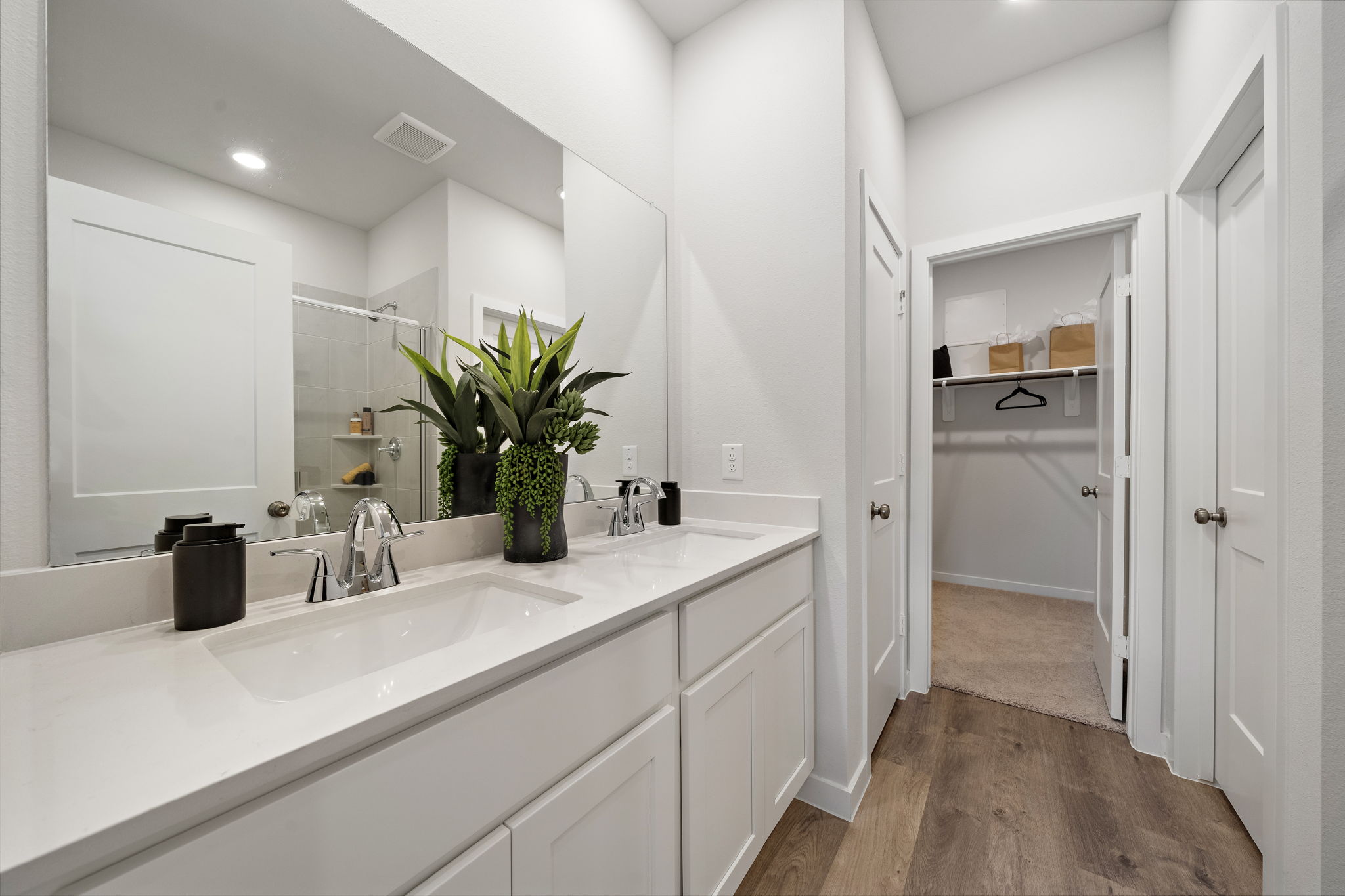 A bathroom with white cabinets.