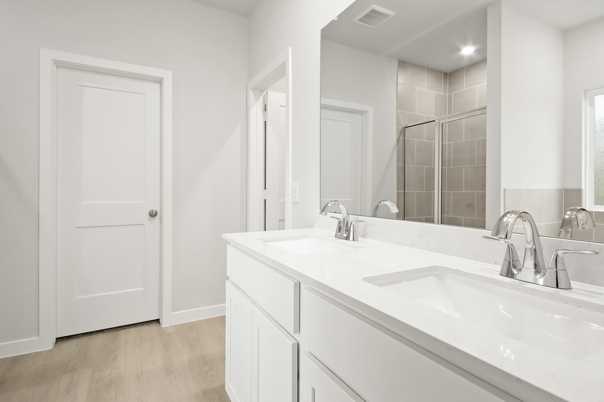 A bathroom with a large mirror.