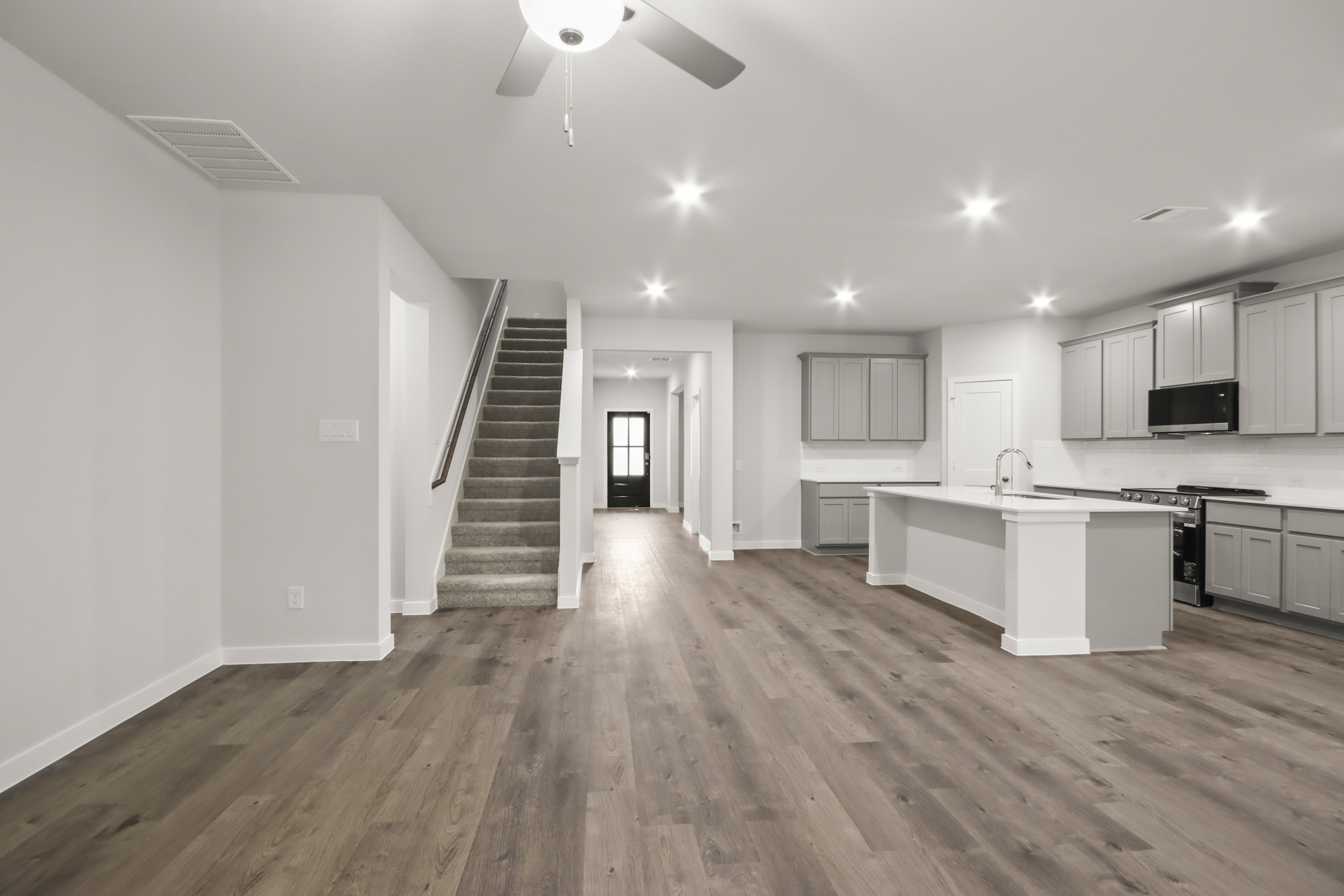 A large kitchen with white cabinets.