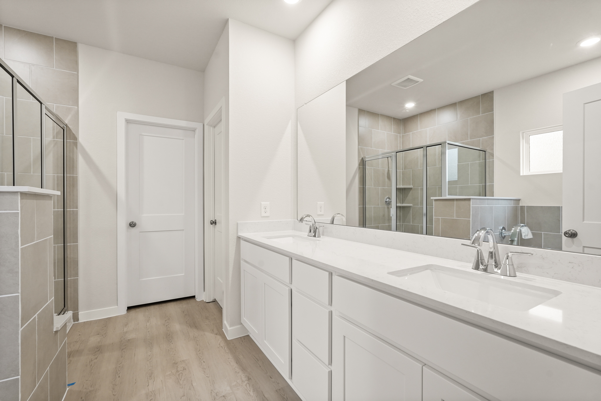 A bathroom with a large mirror.