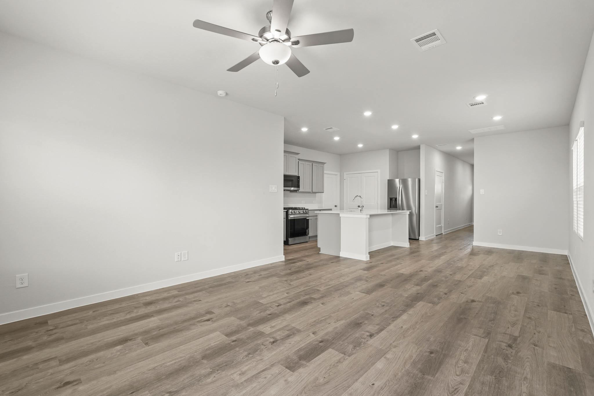 A kitchen with a wood floor.