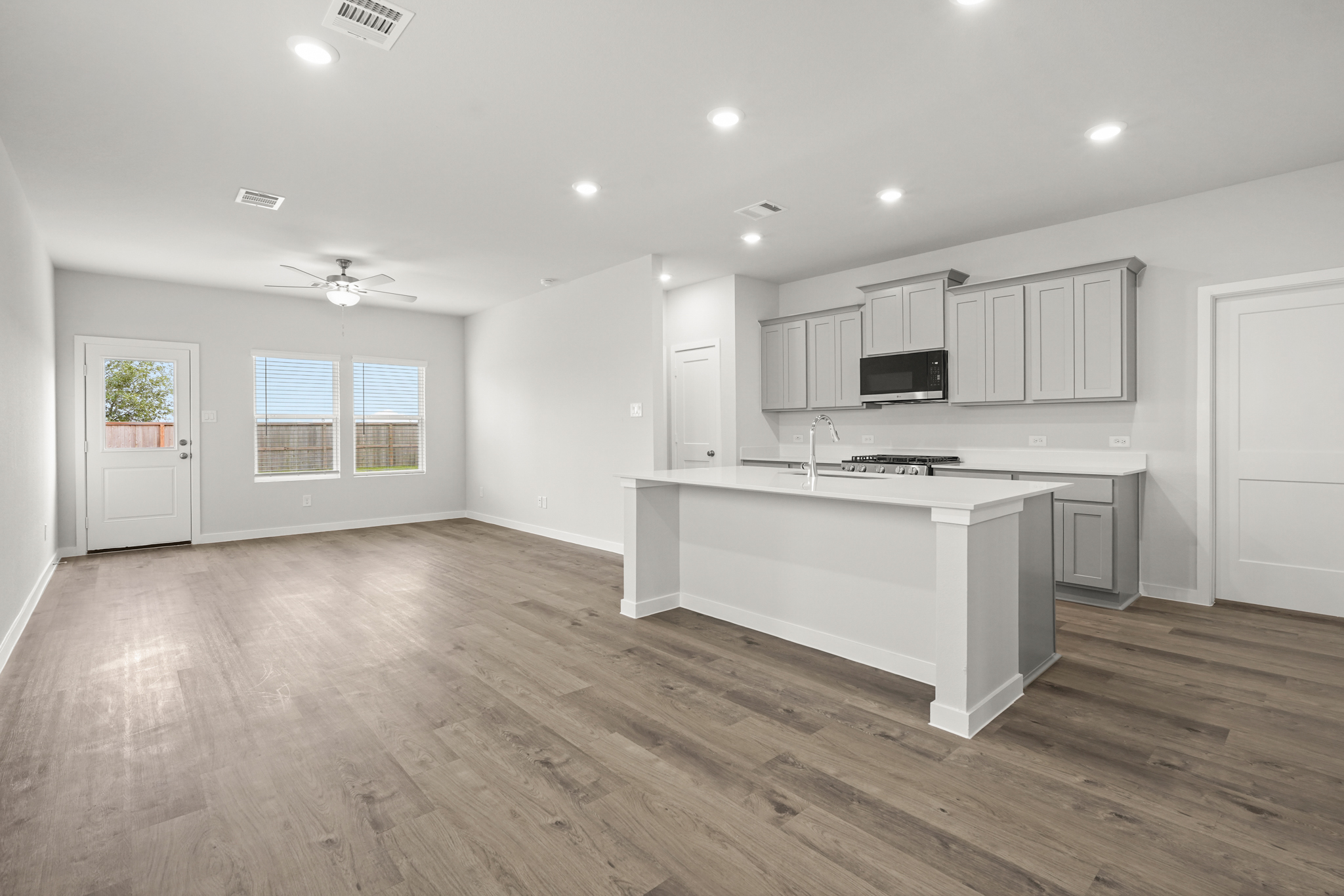 A kitchen with white cabinets.