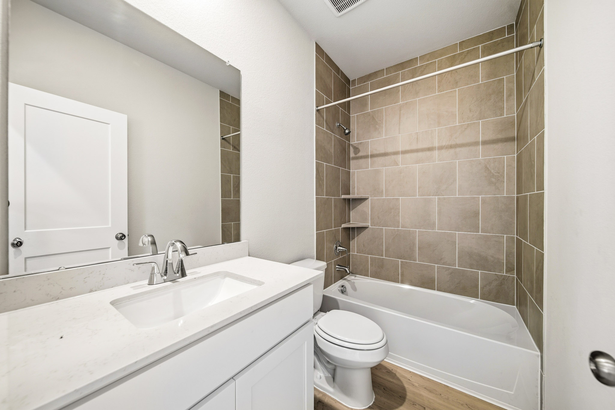 A bathroom with a tub sink and toilet.