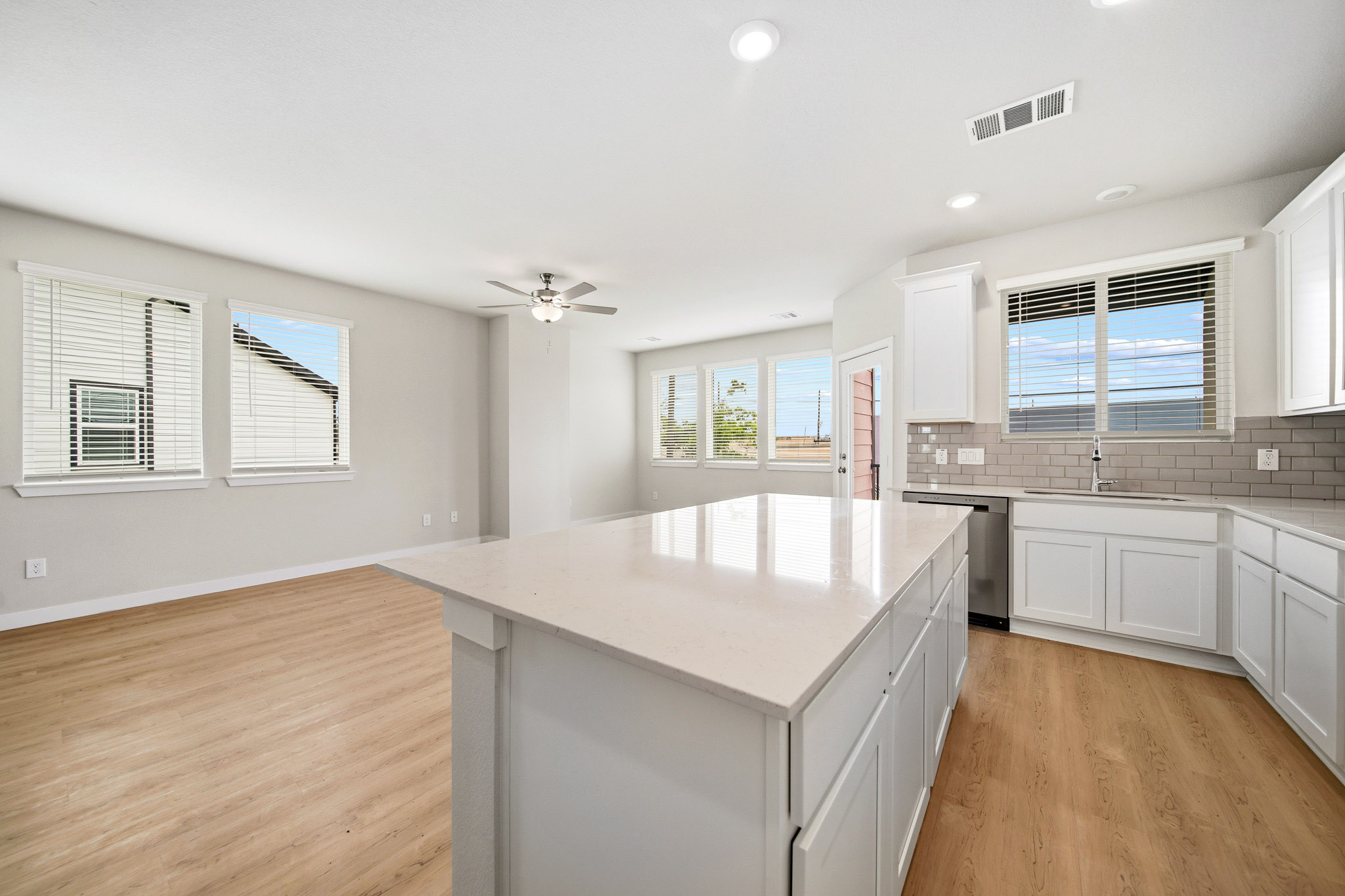 A kitchen with white cabinets.