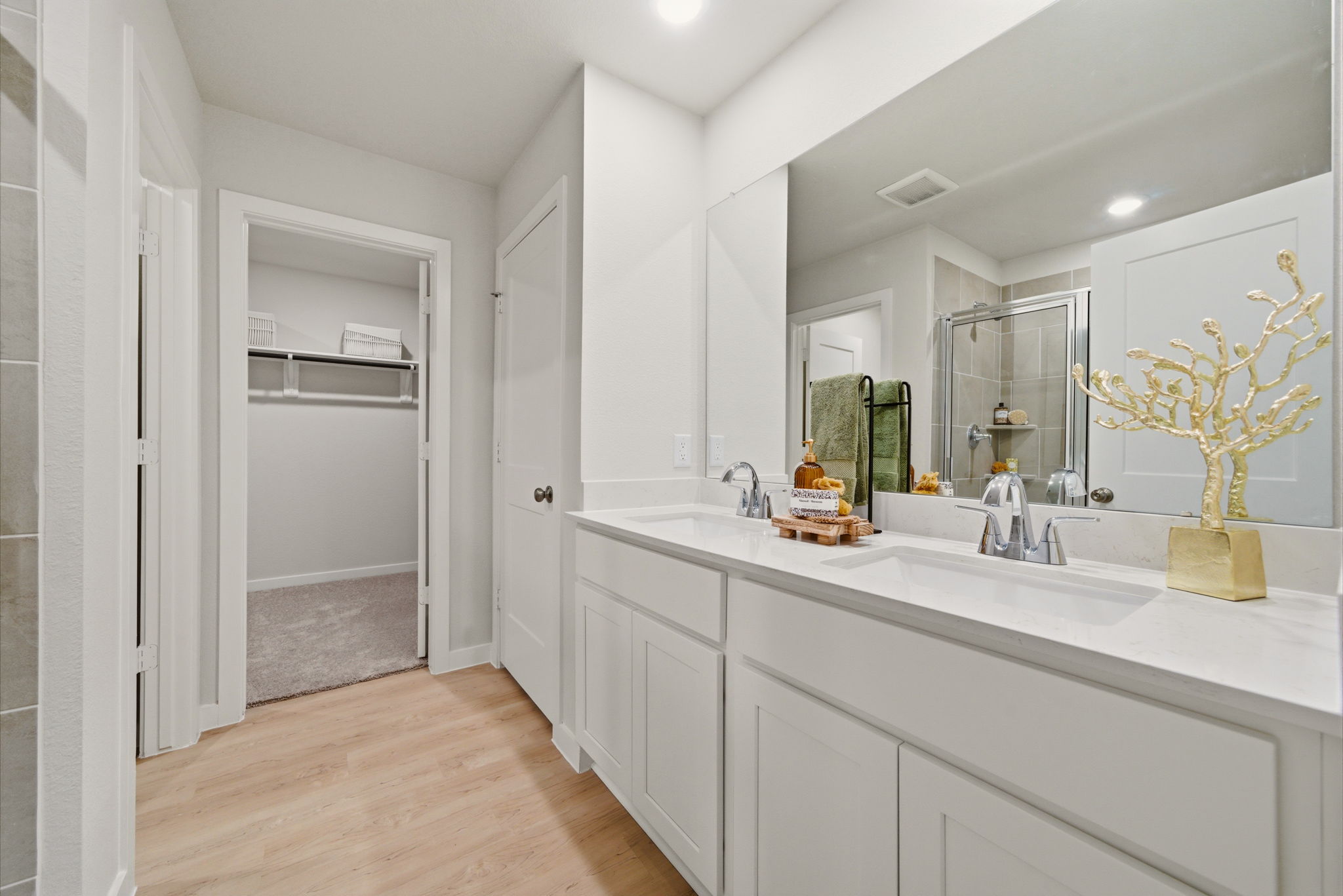 A bathroom with white cabinets.