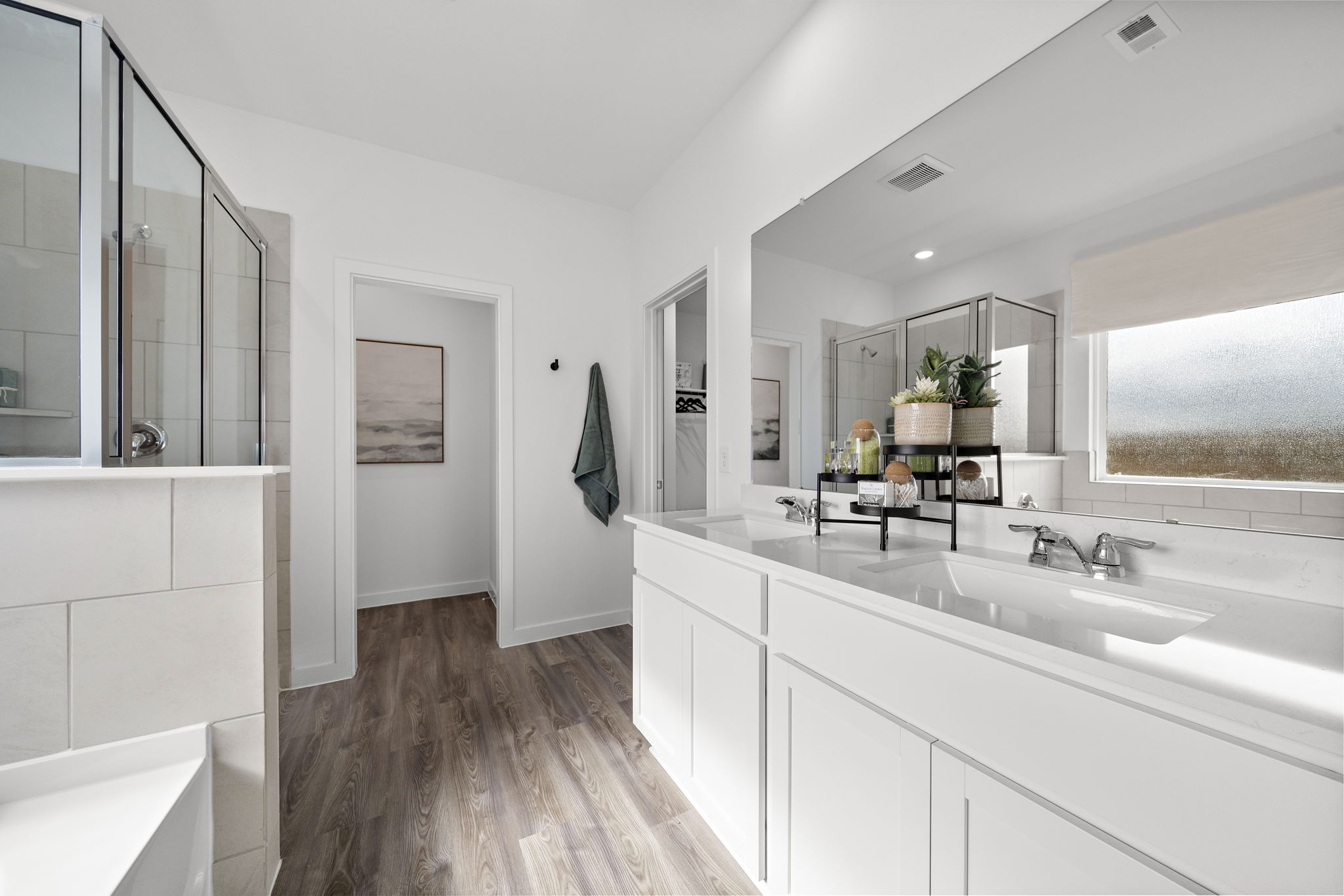 A bathroom with white cabinets.