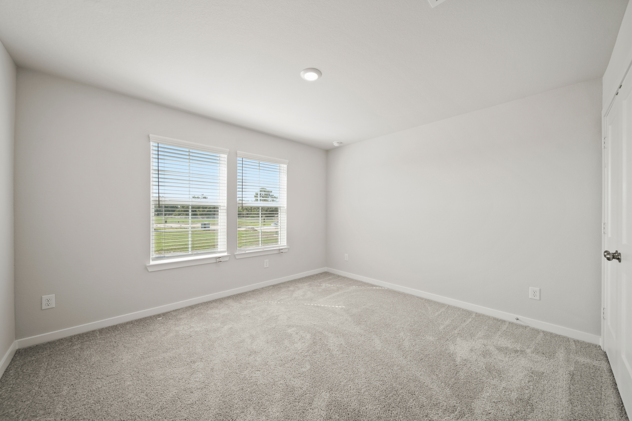 A room with a window and a carpet.