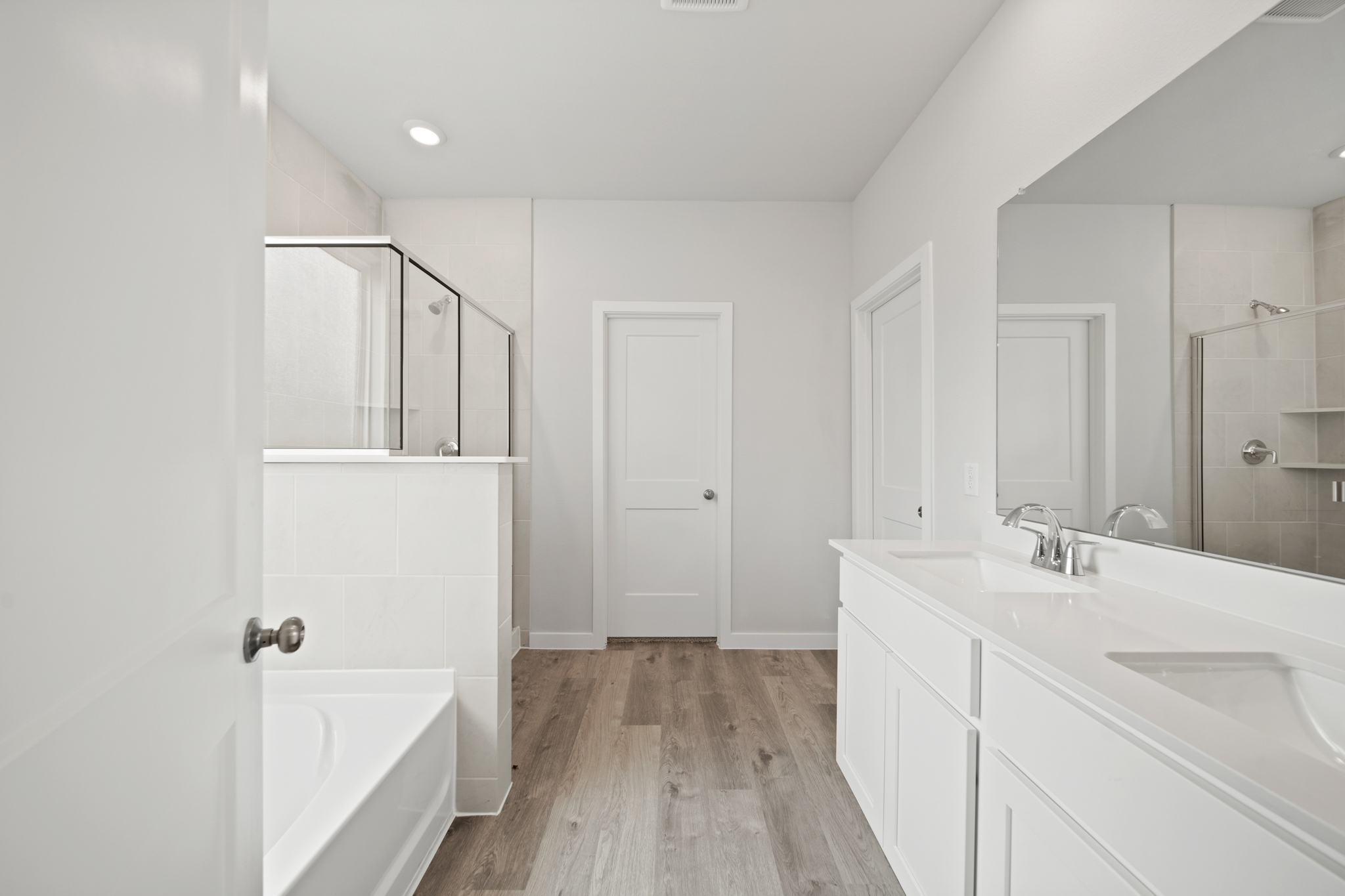 A bathroom with white cabinets.