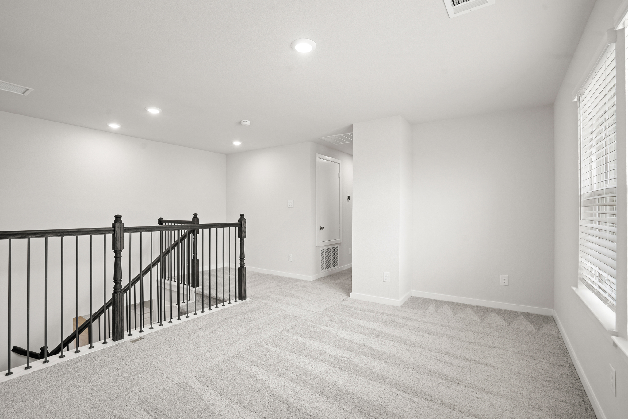 A hallway with a railing.