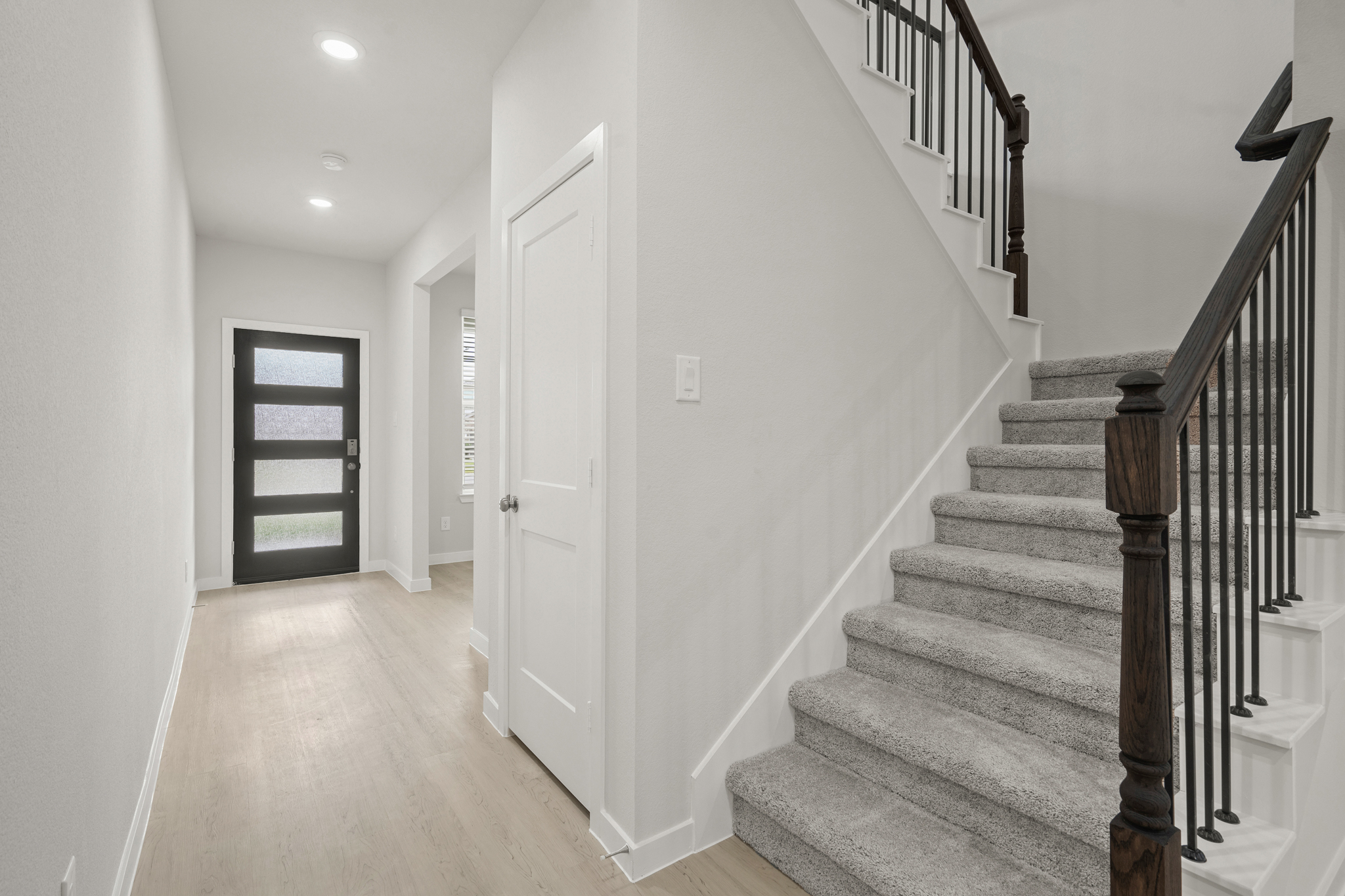 A staircase with white doors.