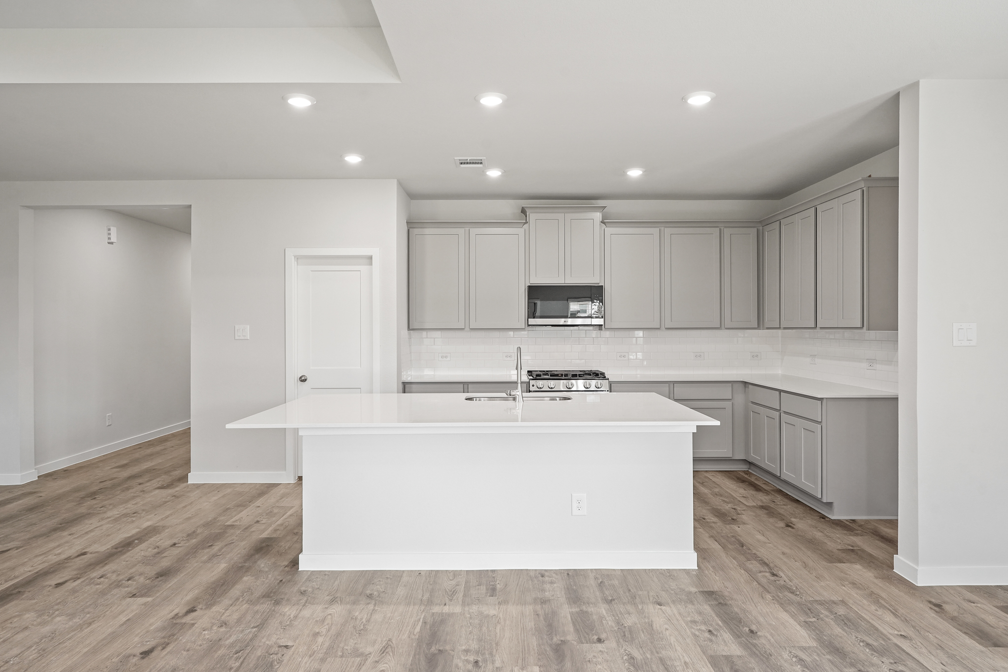 A kitchen with white cabinets.