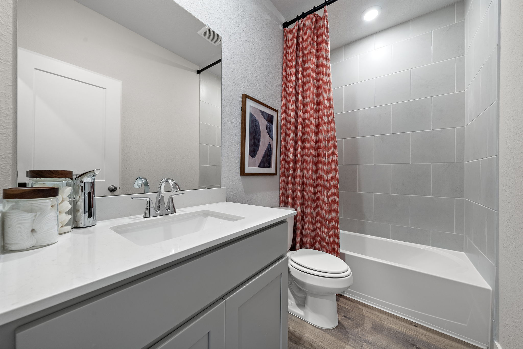 A bathroom with a sink toilet and bathtub.