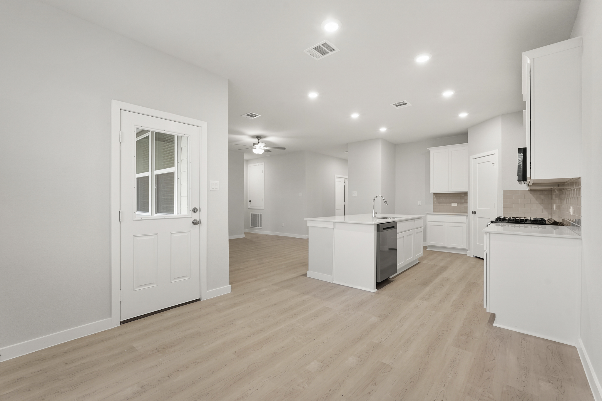 A kitchen with white cabinets.
