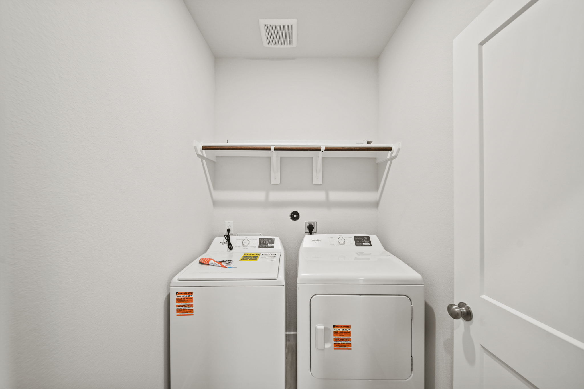 A white room with a washer and dryer.