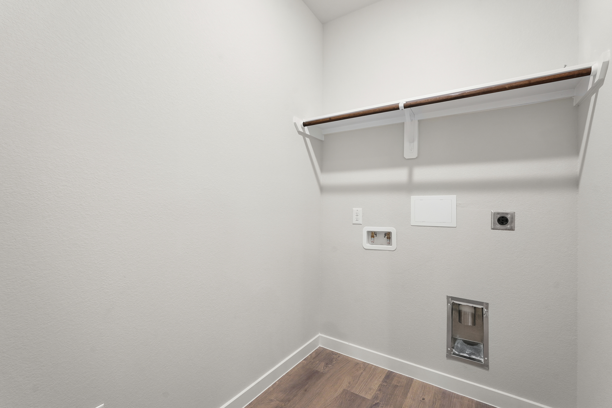A white wall with a light fixture.