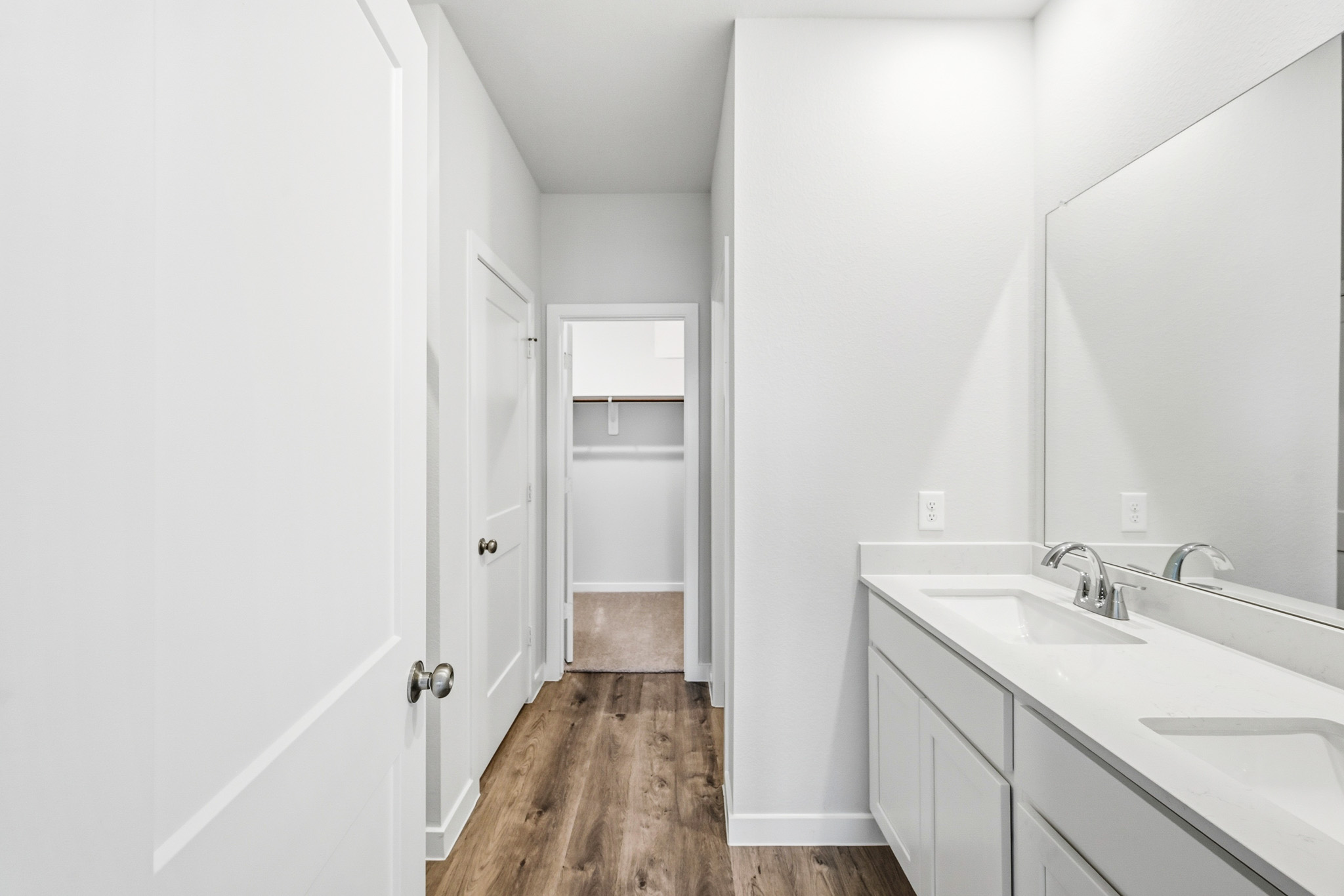 A bathroom with white cabinets.