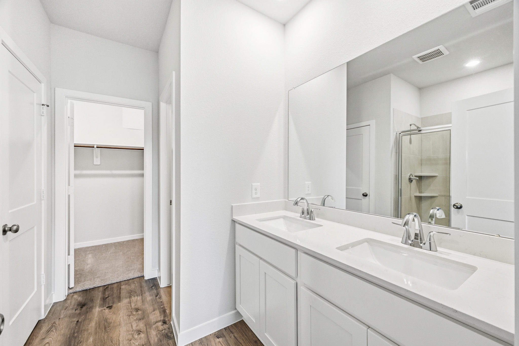 A bathroom with a large mirror.
