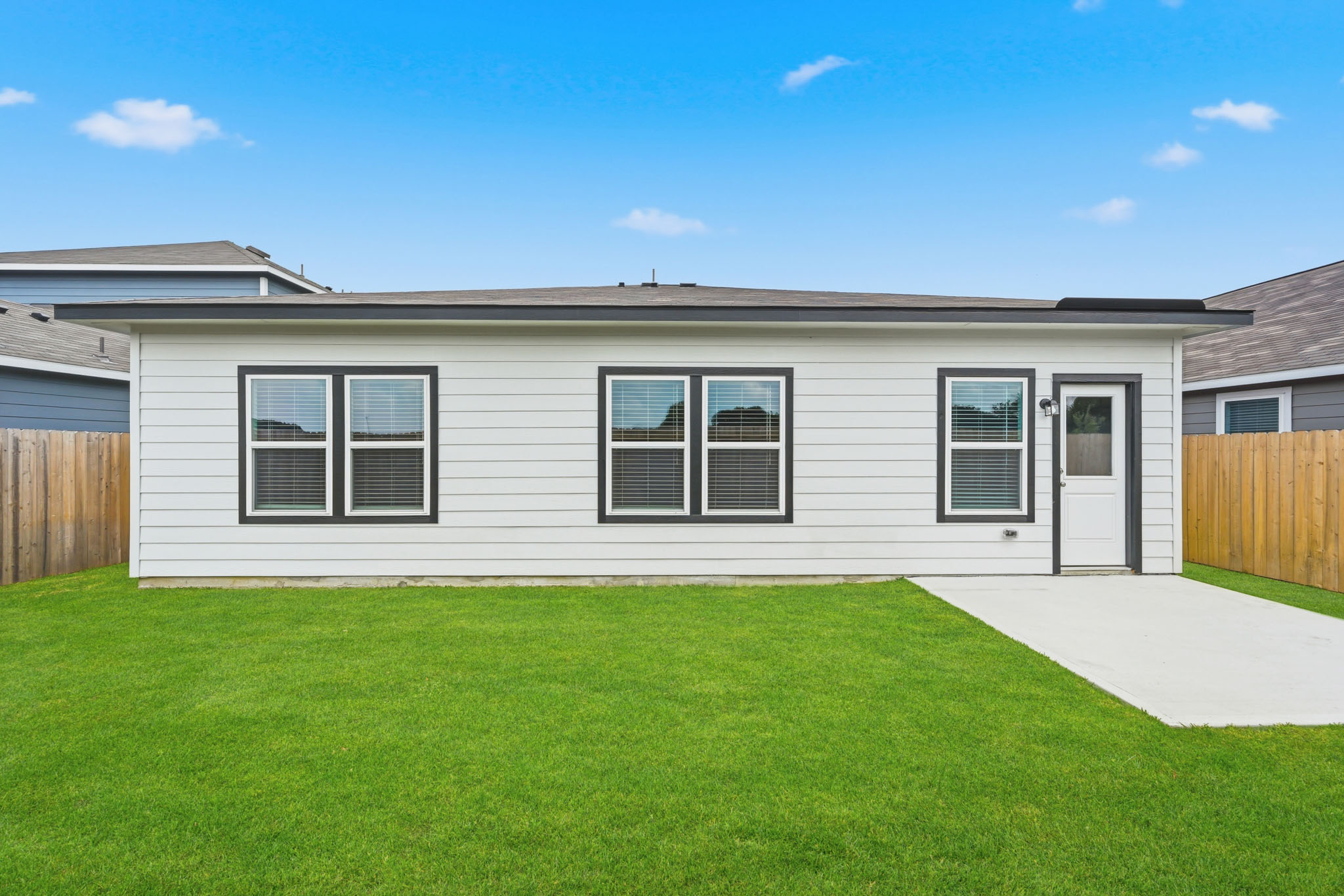 A house with a green lawn.