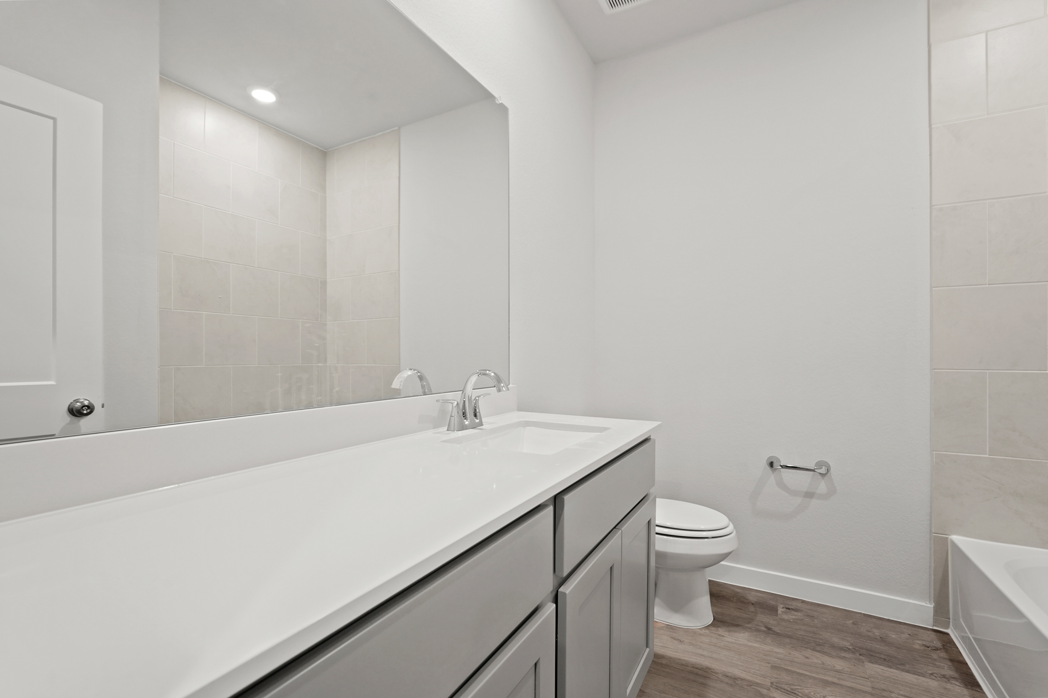 A bathroom with a tub toilet and sink.