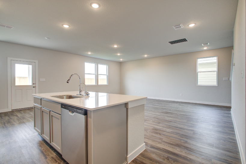 A kitchen with a sink and cabinets.